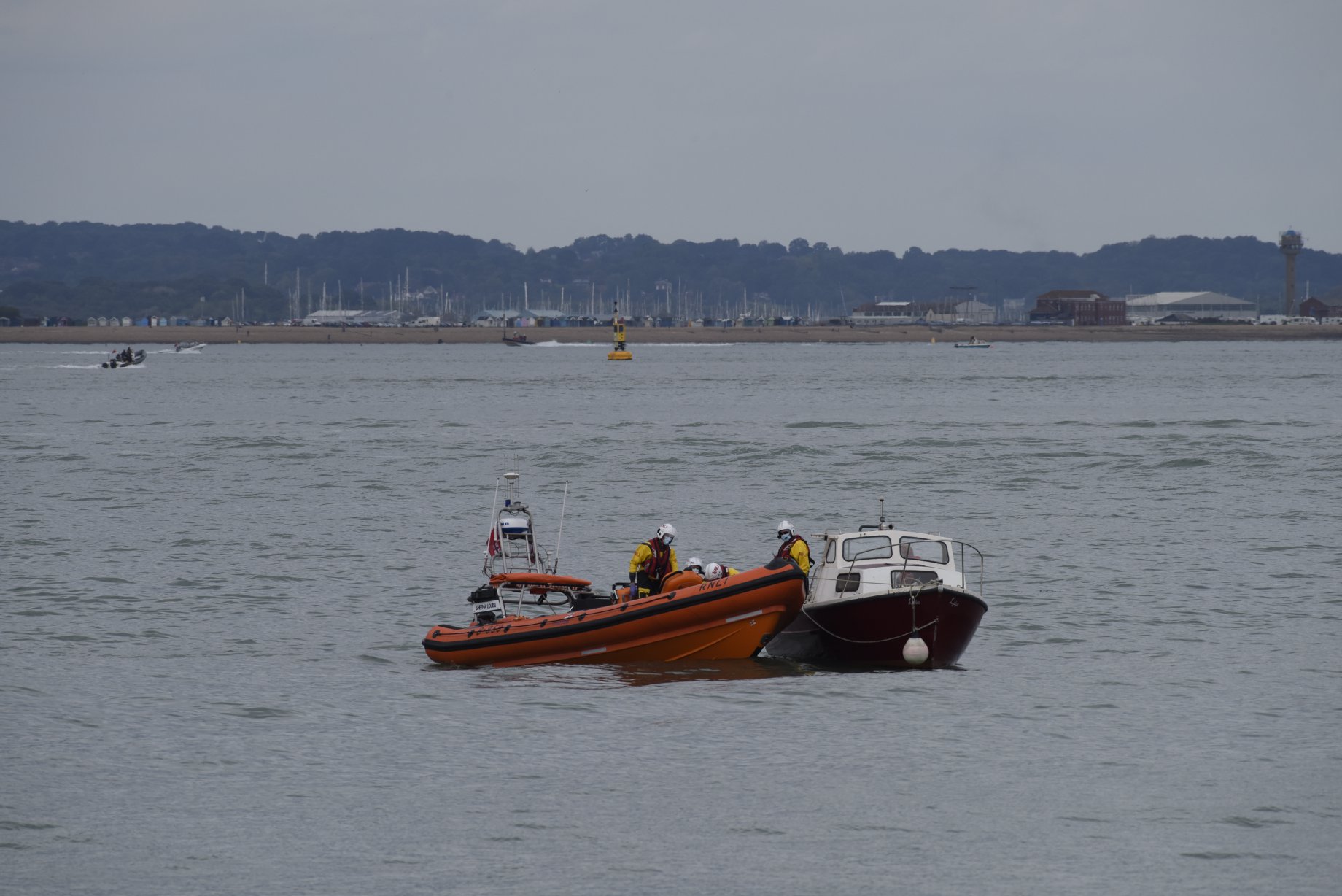 Photo of the Cowes lifeboat arriving alongside the fishing boat.