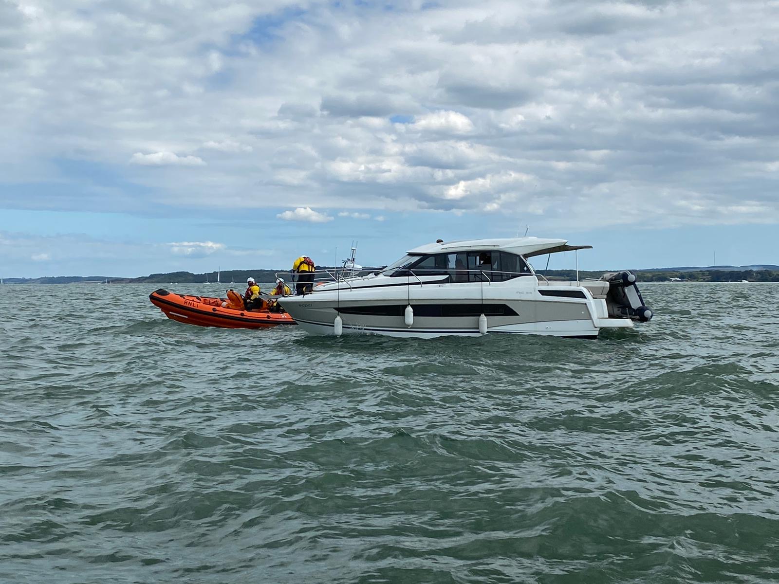 The Lymington RNLI lifeboat with the casualty vessel.
