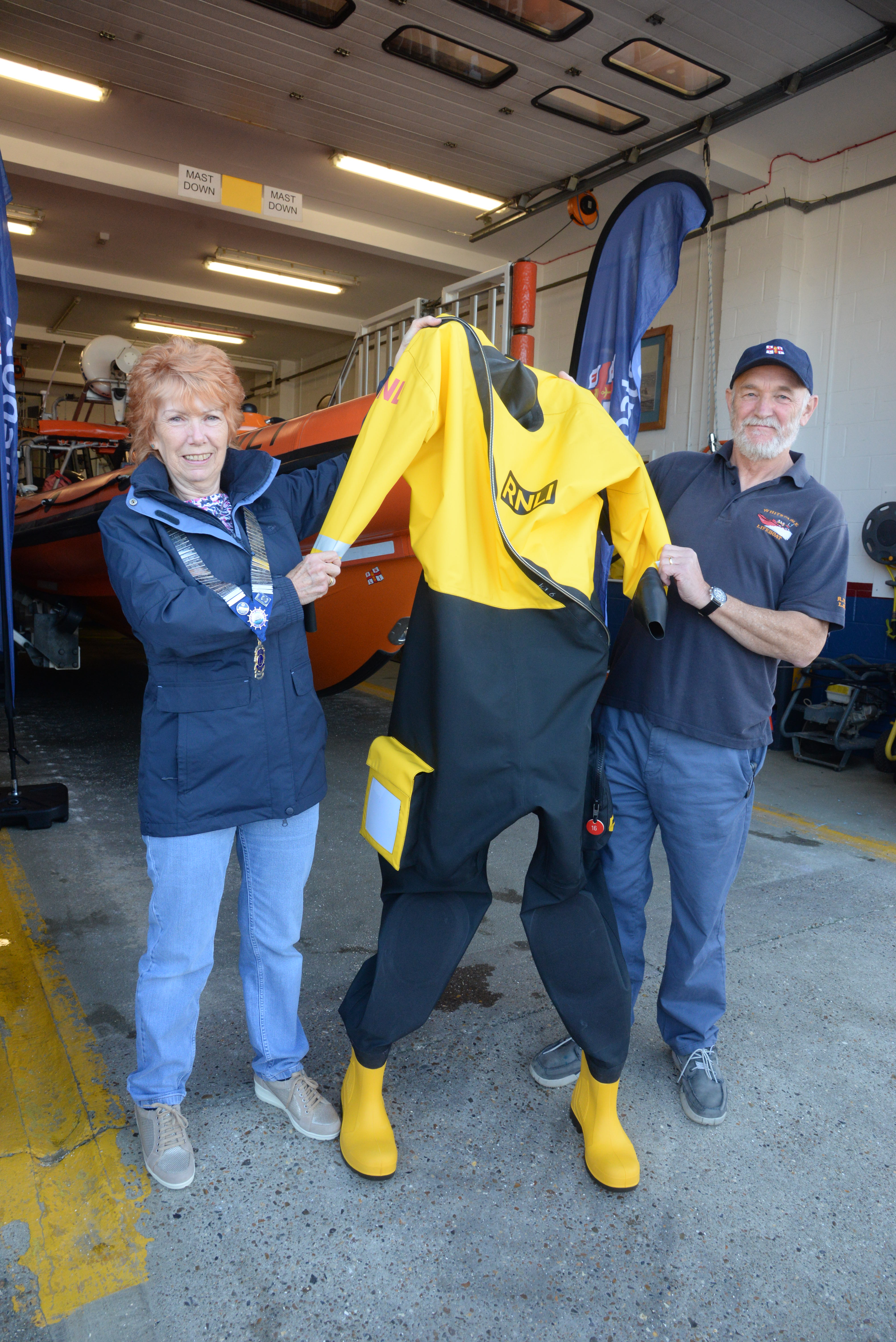 Whitstable and Herne Bay Lions Club president Fiona Page and lifeboat operations manager Mike Judge with the dry suit that the club has made a £300 contribution towards its cost.