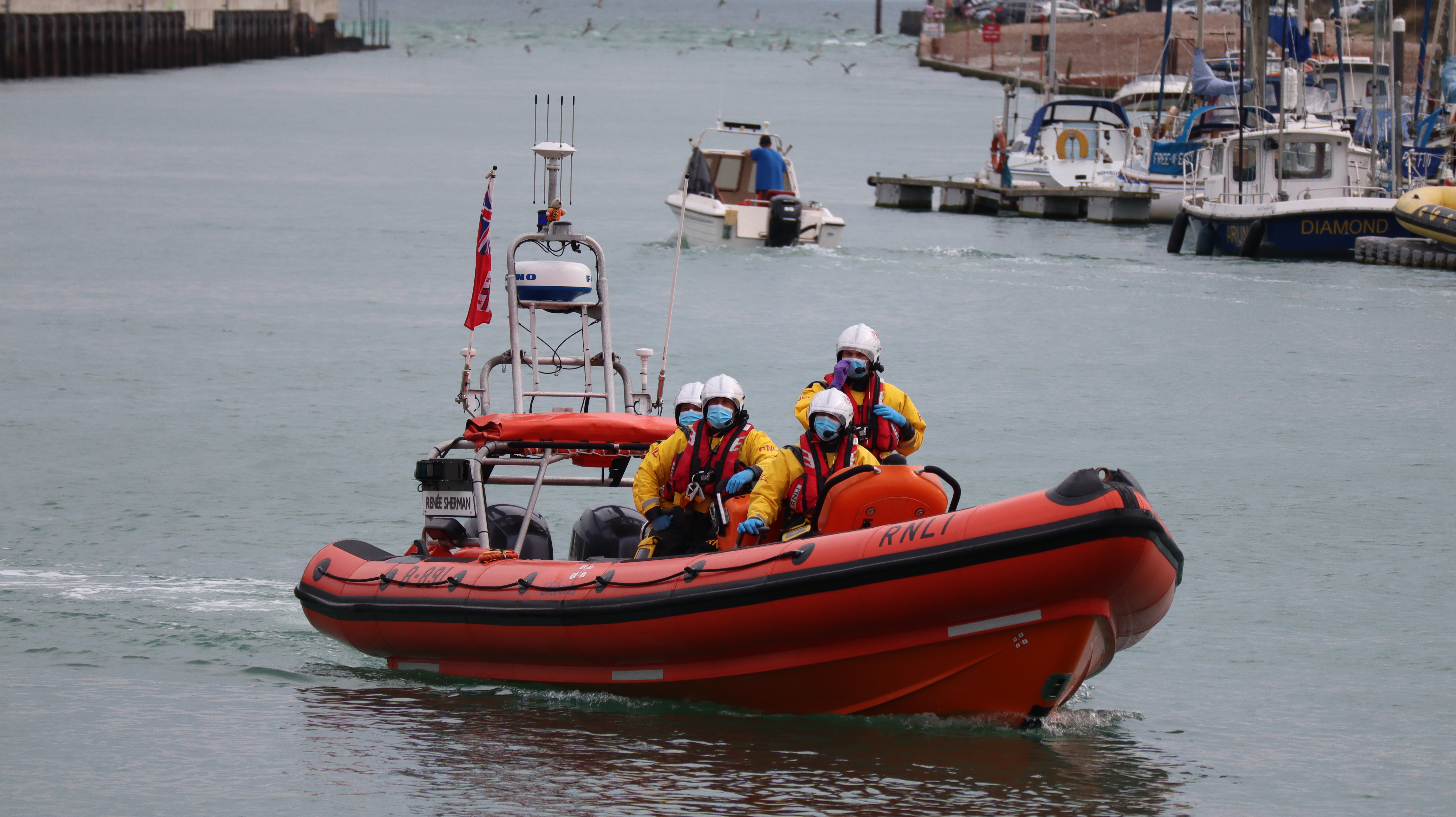 The volunteer crew of Littlehampton RNLI return to the lifeboat station after their first shout of the day