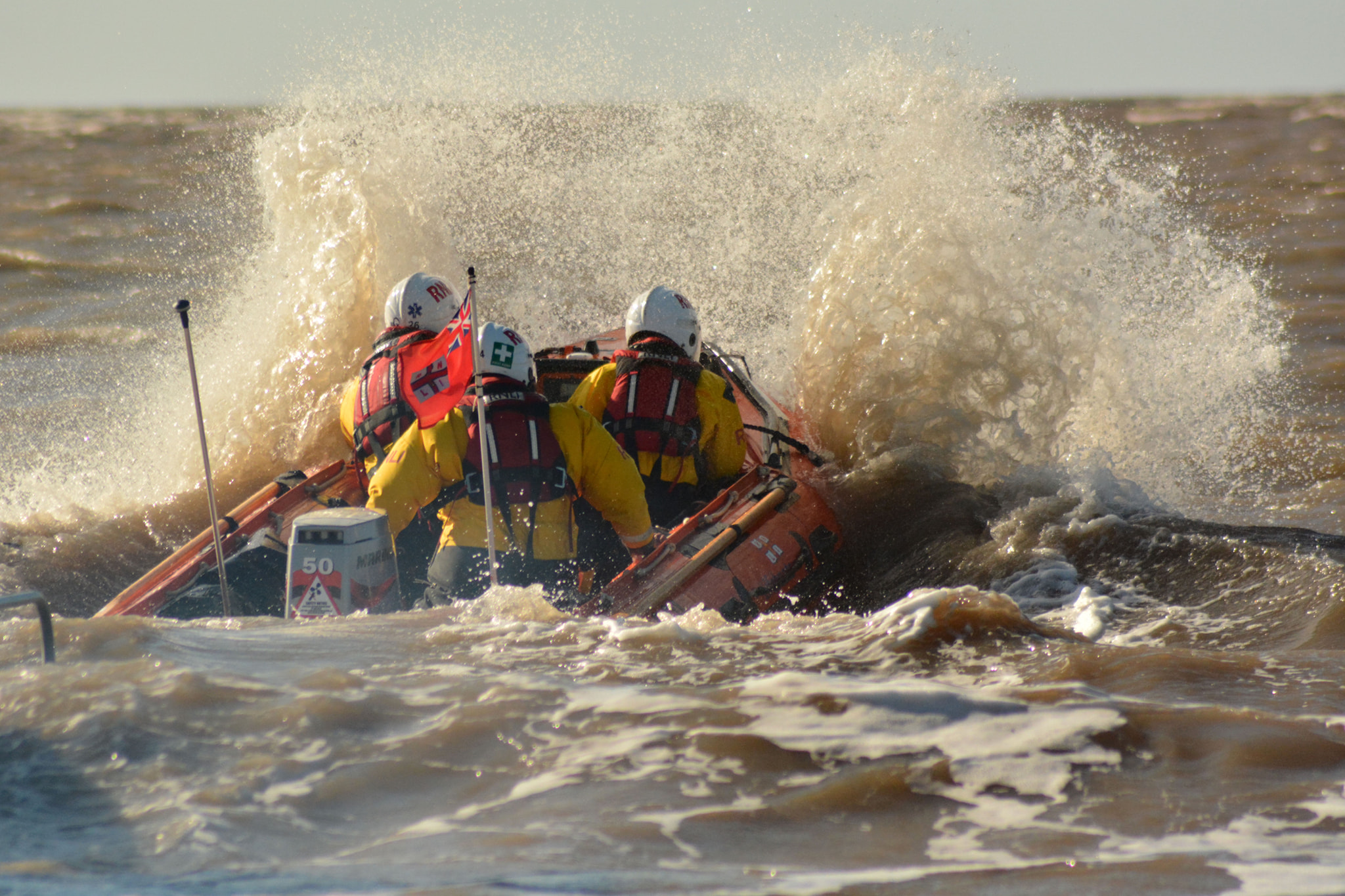 D Class lifeboat Burnham Reach proceeds to sea in a stiff on-shore breeze