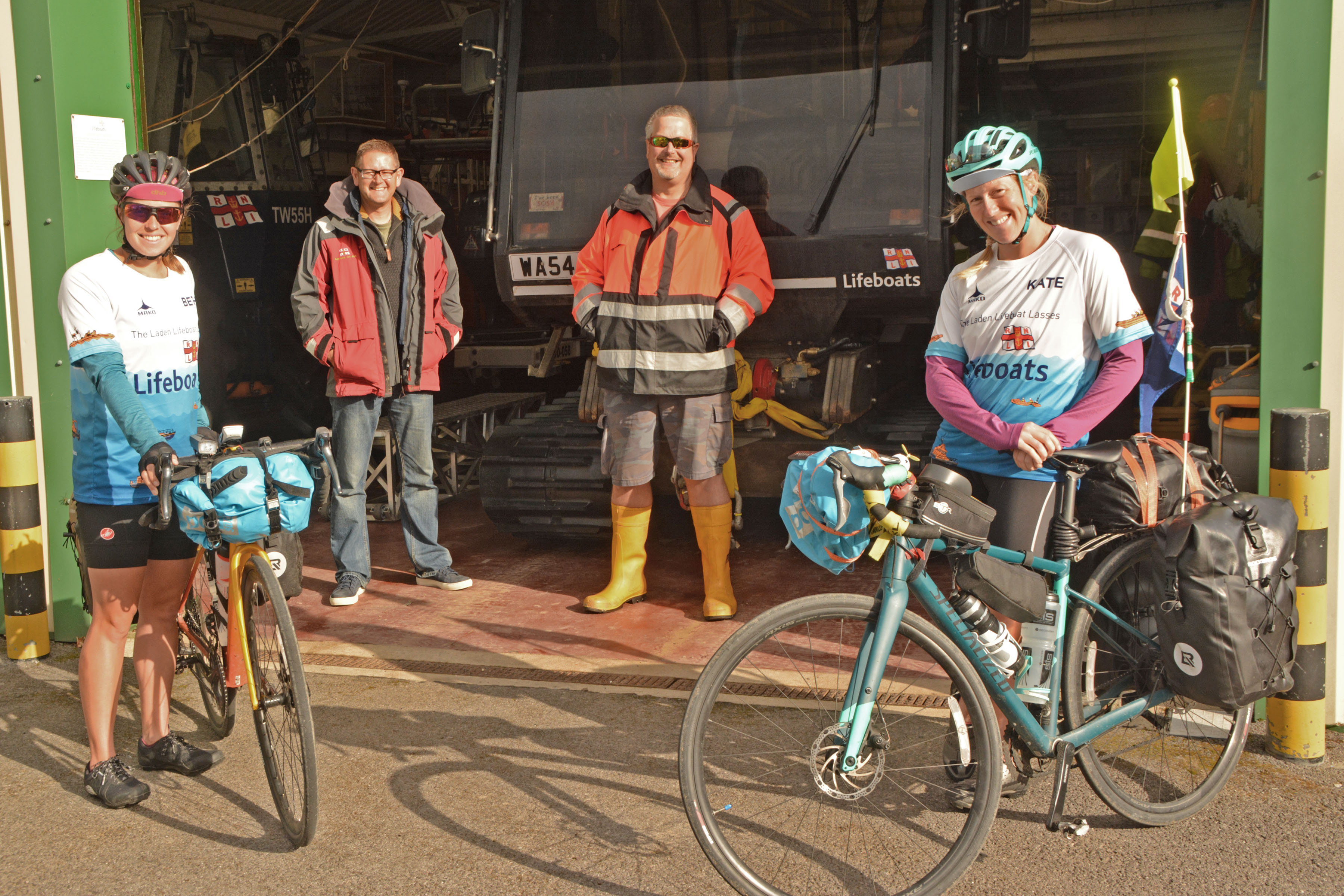 Kate Bourn and Beth Barratt in front of Burnham-on-Sea lifeboat station with Crewmember Dan Fear, and Head Launcher Ian Brown