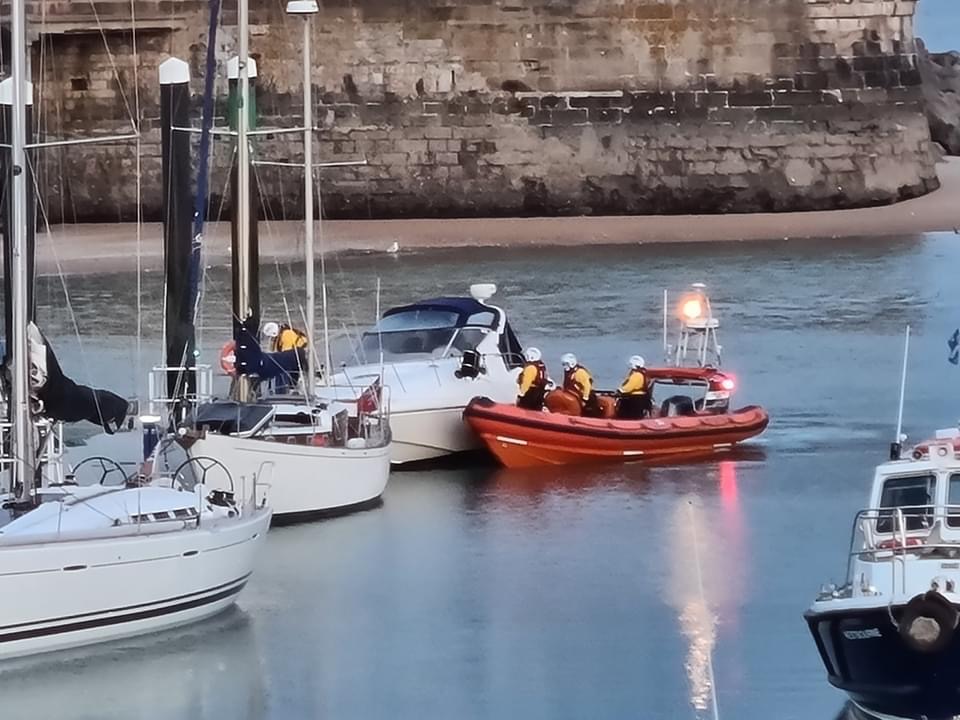 The lifeboat pushing the vessel against the pontoon.