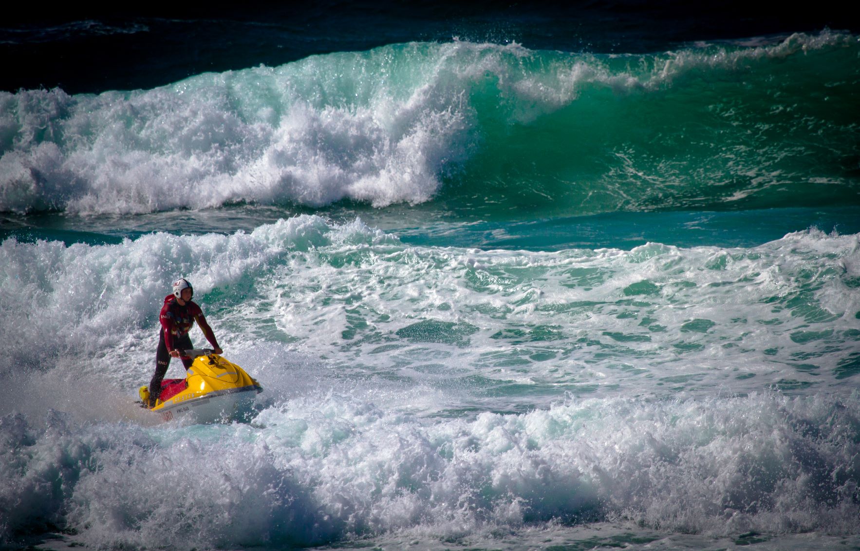RNLI lifeguard on Rescue Water Craft in big waves