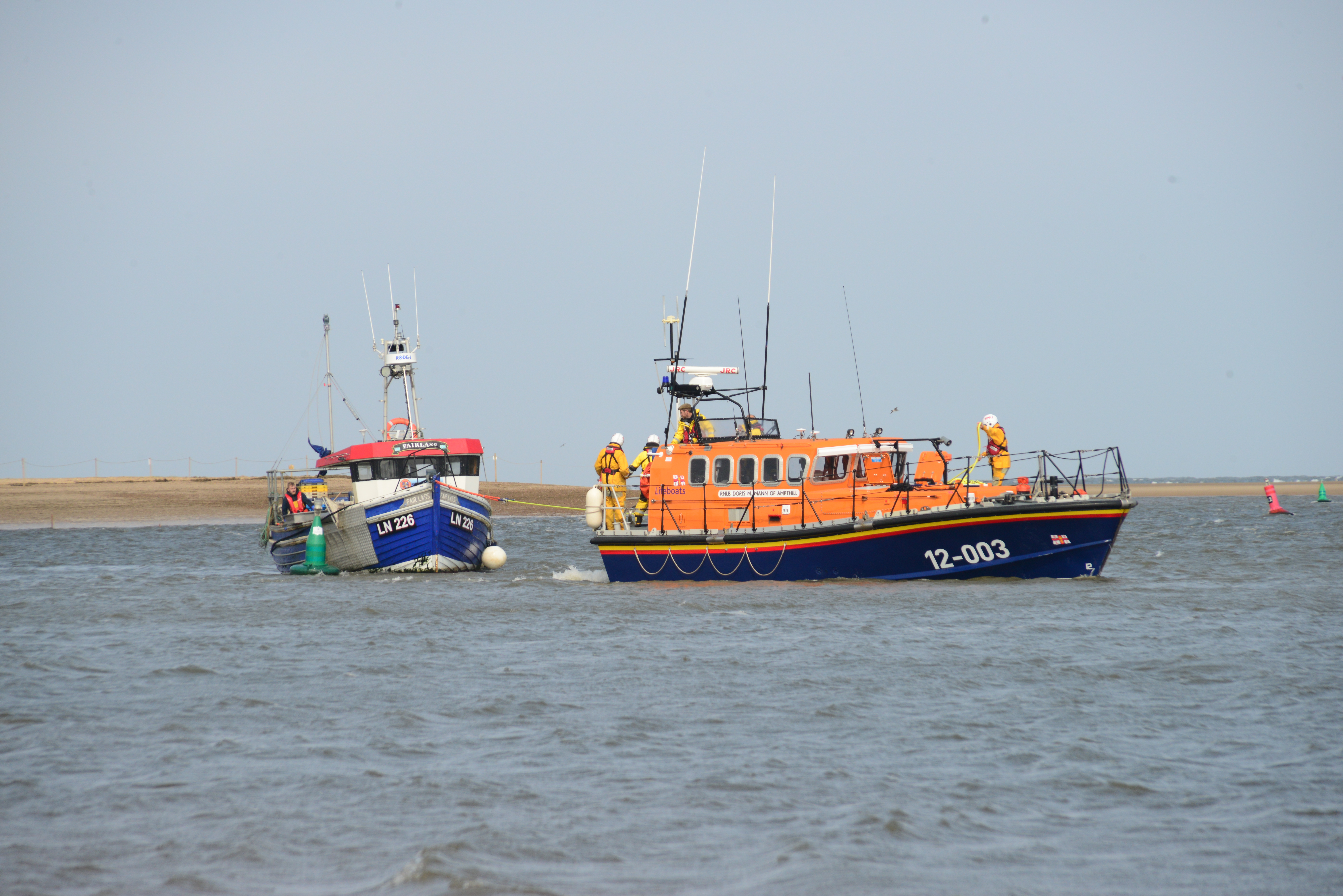 Local fishing boat being towed back to Wells