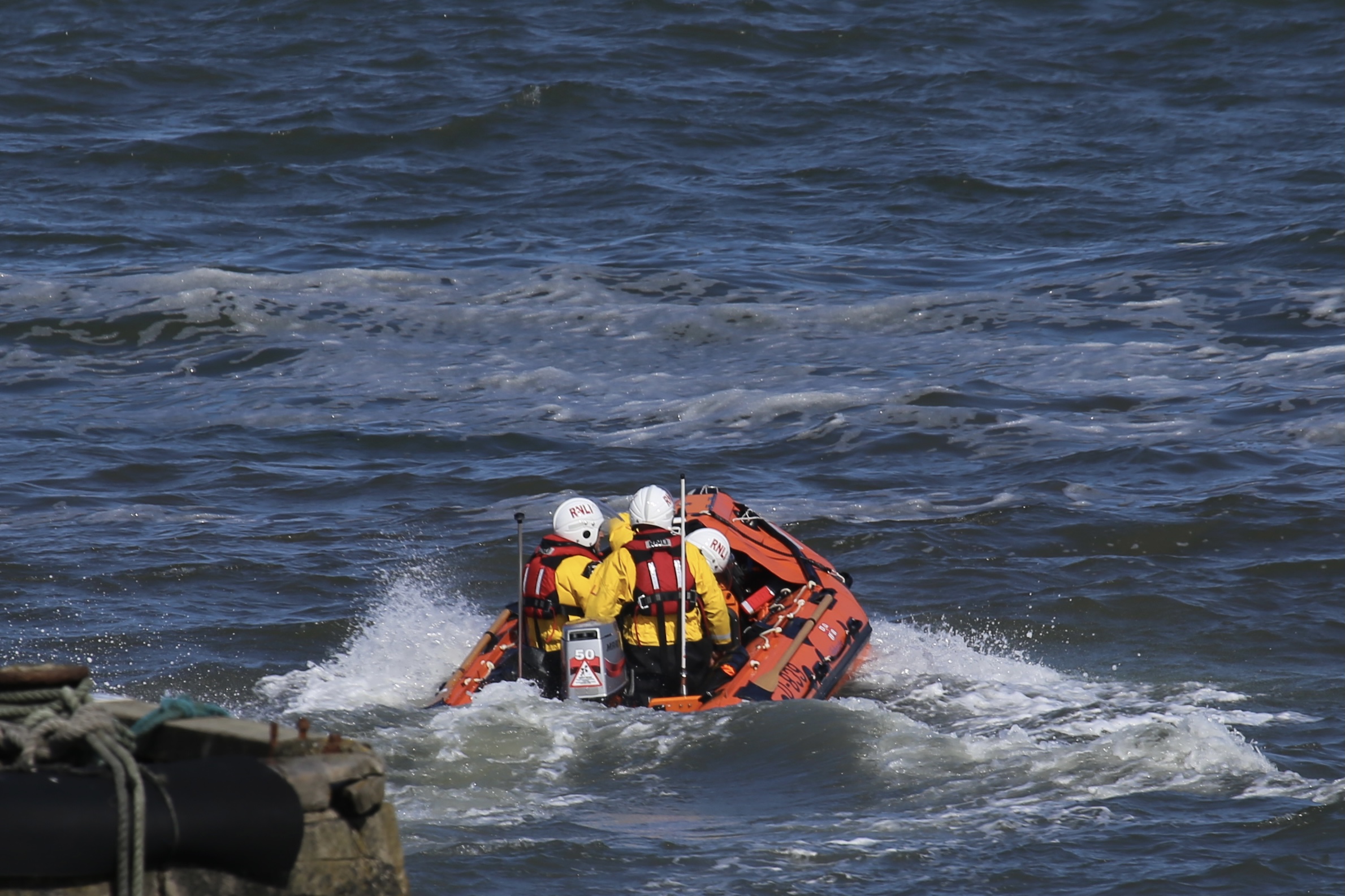 Craster lifeboat leaving the harbour to head south to the beaches yacht