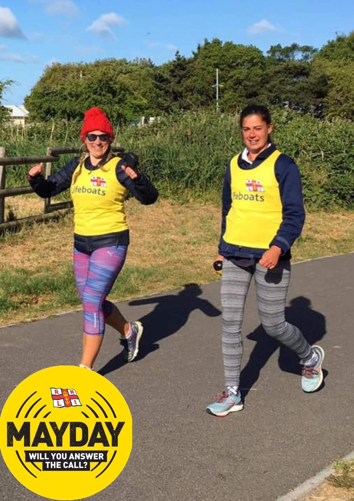 Volunteers in yellow vests running and smiling!