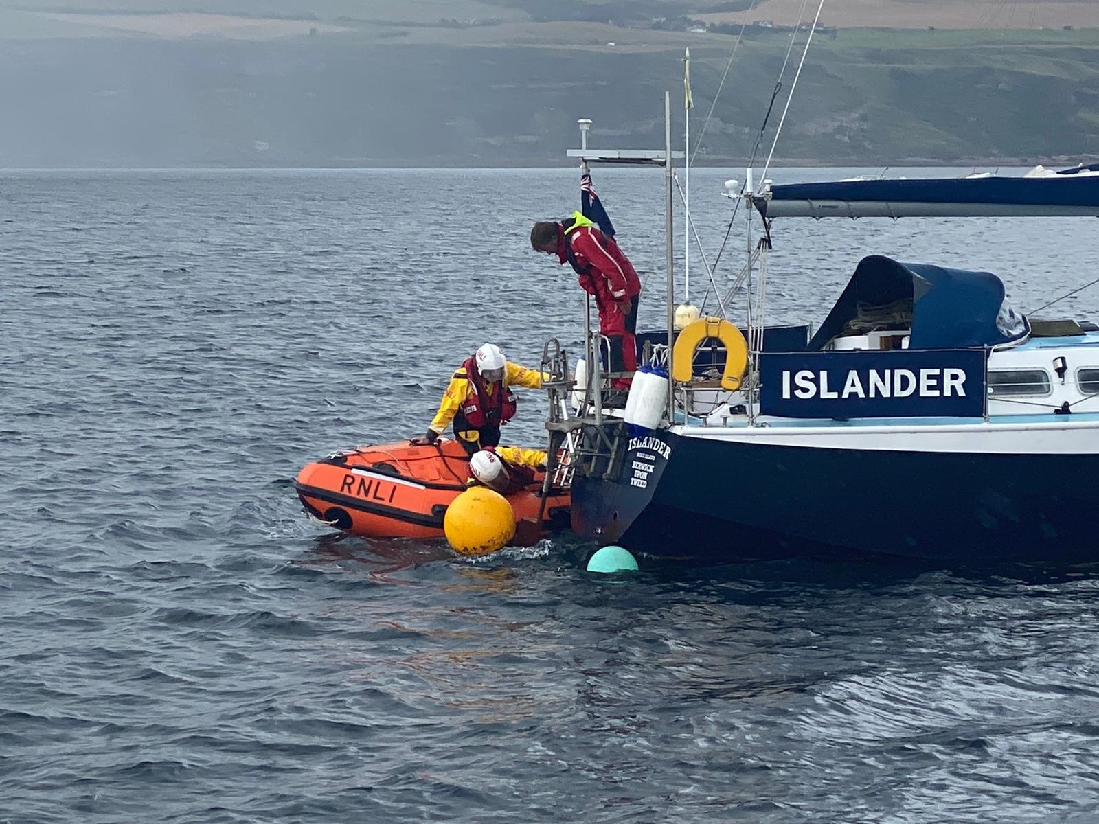 RNLI inshore lifeboat Crew assess the situation