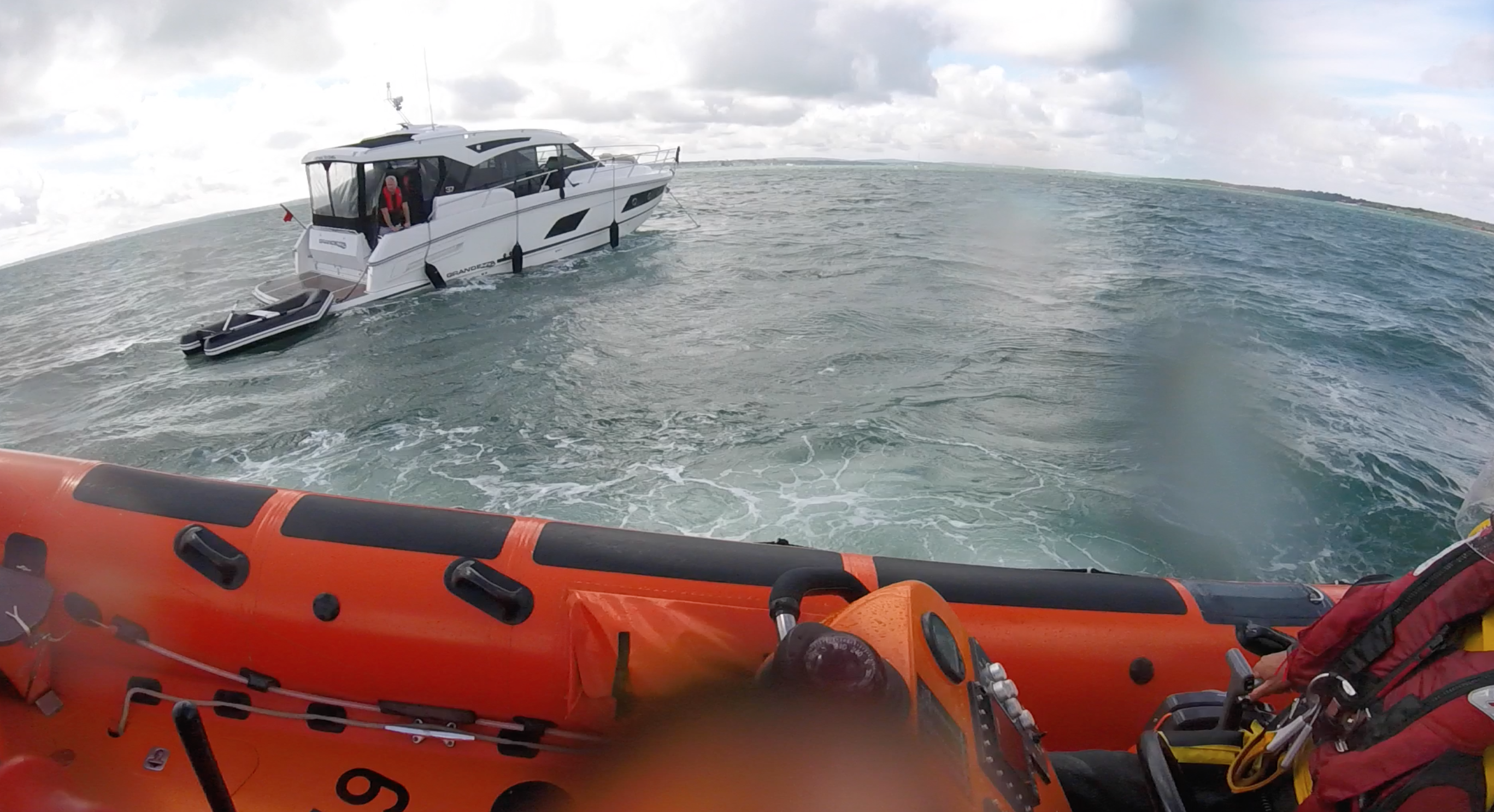 The lifeboat approaches the grounded motor-crui8ser.