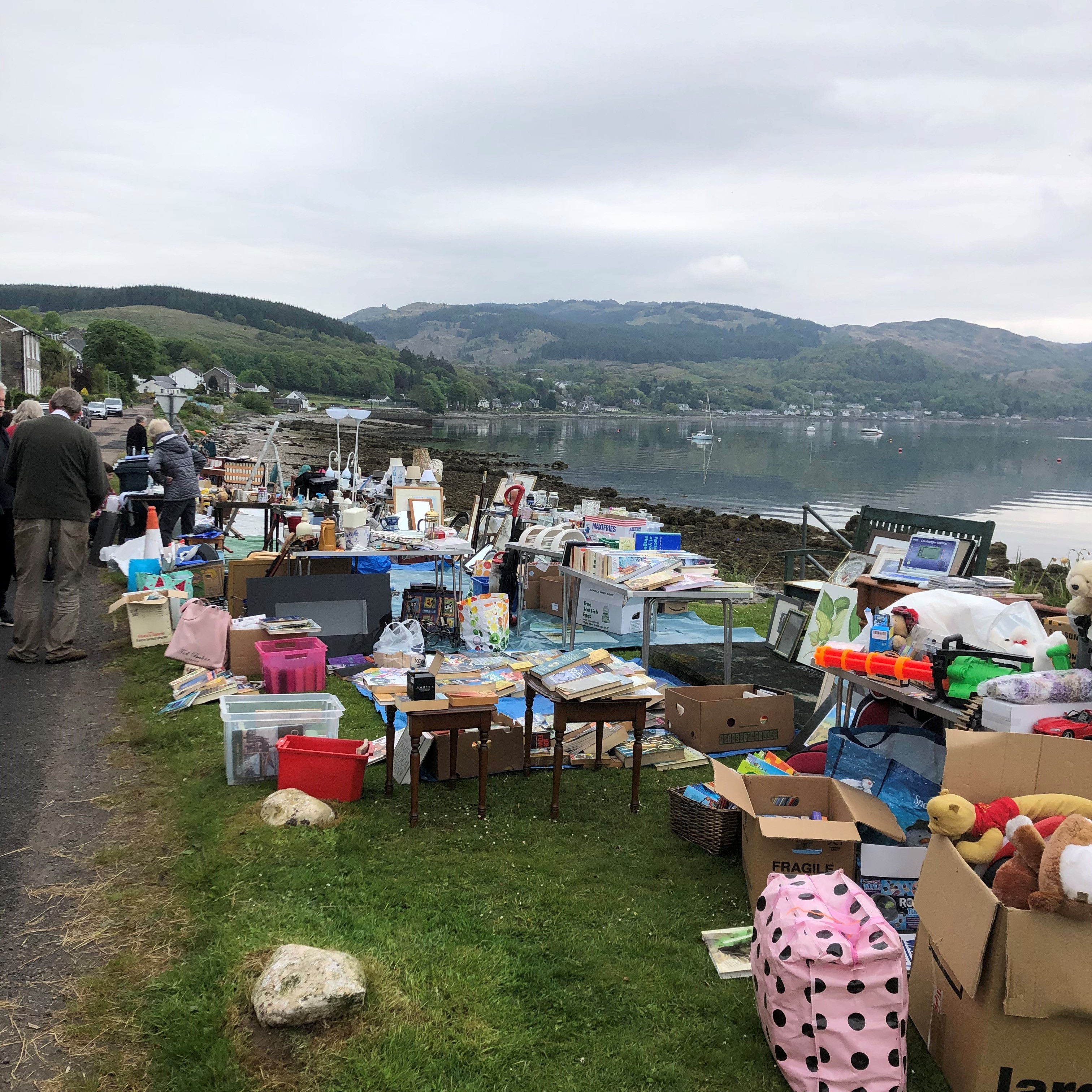 Street sale of items to raise local funds taking place on the shore at Kames, Tighnabruaich