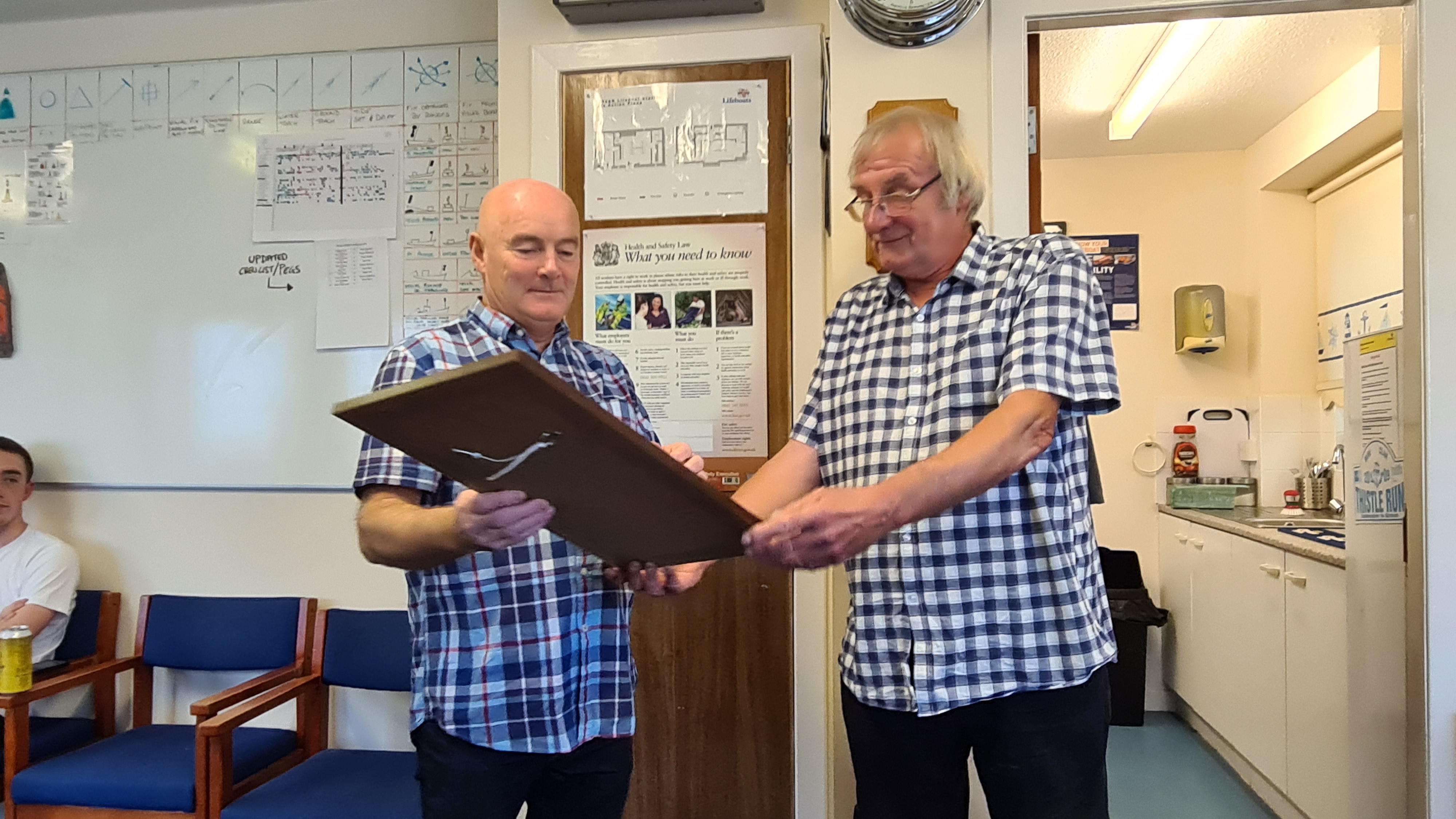 Deputy Launching Authority Thomas Houston receiving his vellum in recognition of 15 years as sea going crew from Girvan Lifeboat Operations Manager John Gourlay