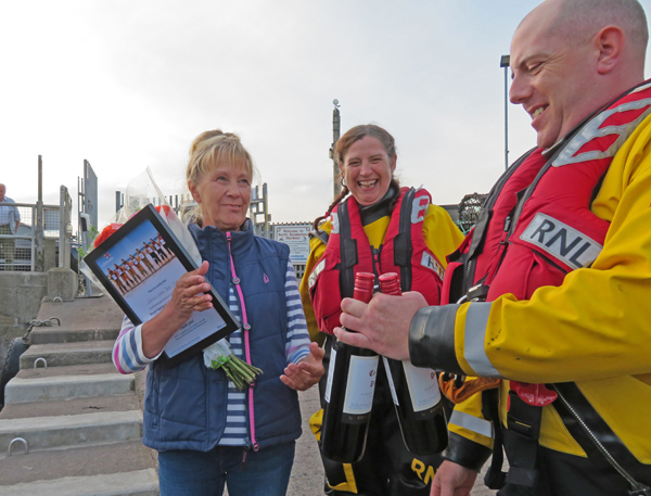 Ailsa Shiel of Golden Gates Farne Island Trips, receiving "thank you" certificate, and wine and flowers from Crew Lynsey Car and Iain Saunders