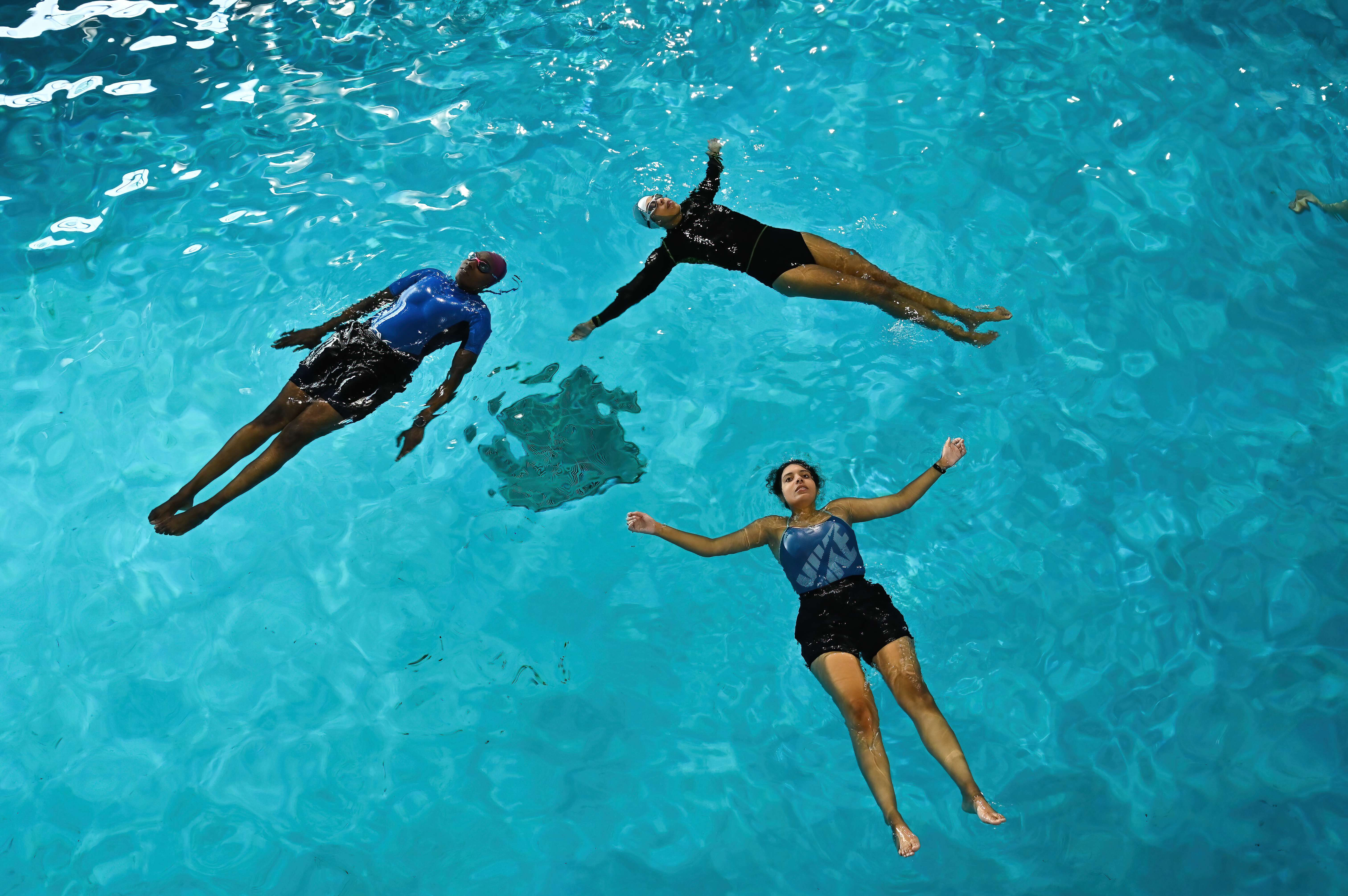 Members and friends of the BSA floating on their backs in the RNLI's state-of-the-art sea survival pool