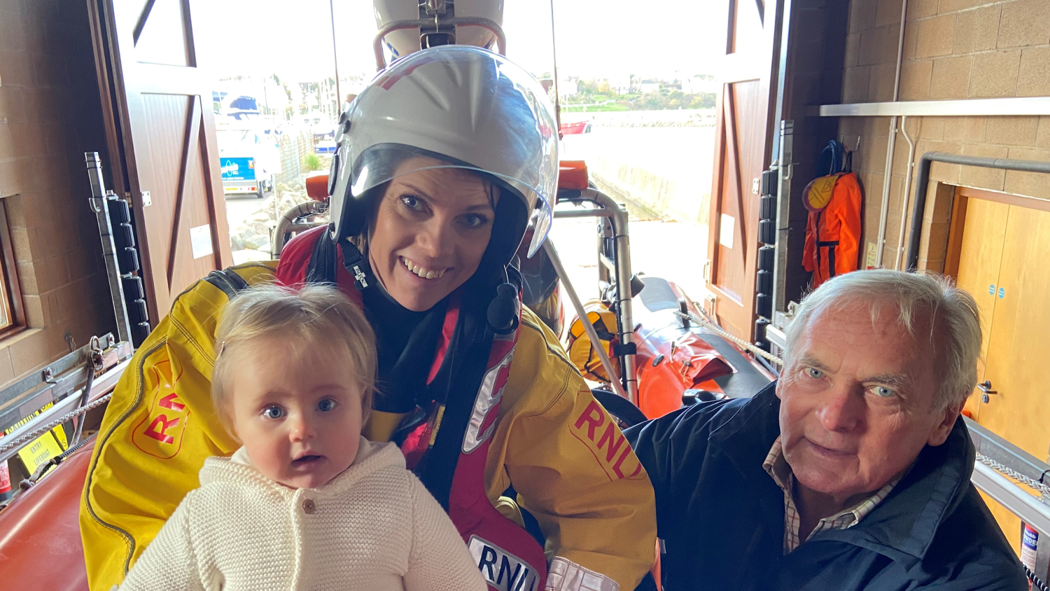 Bangor RNLI crew member Katherine Dunlop pictured with her father Myles Lindsay and her daughter Isla