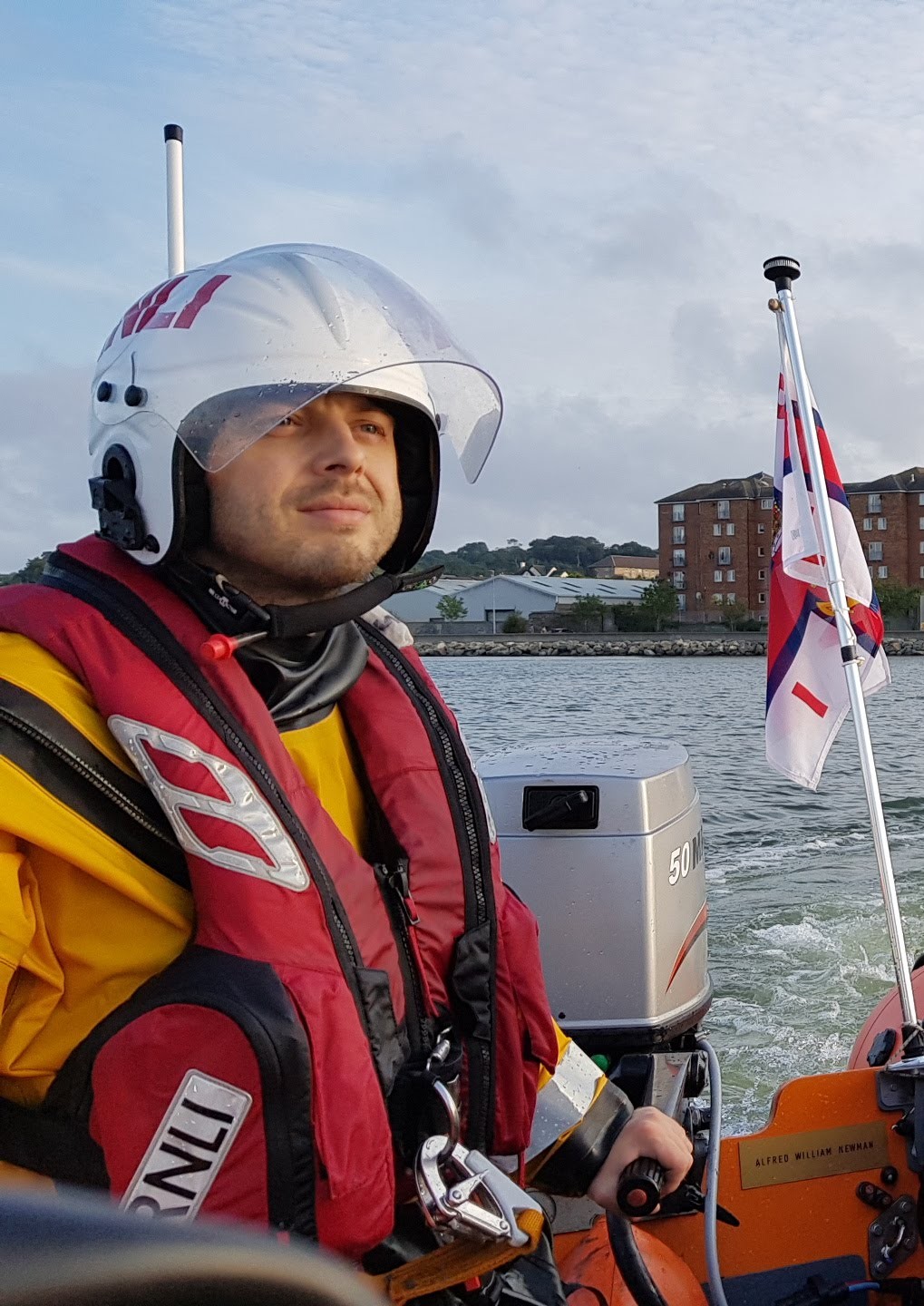 RNLI crew member on the helm