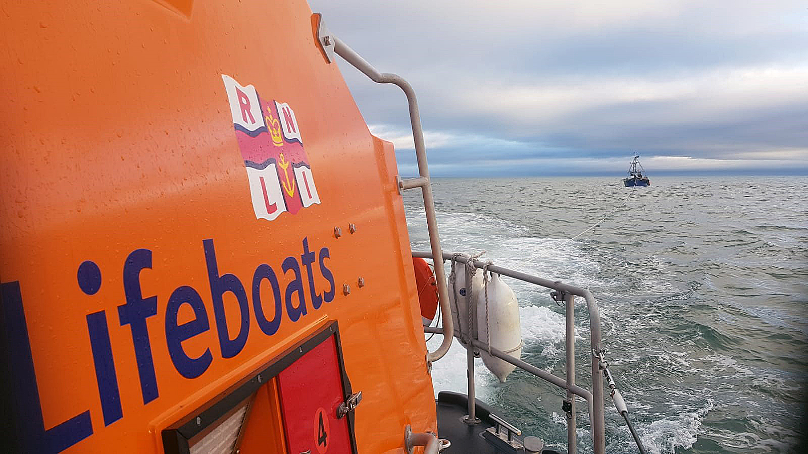Wicklow RNLI lifeboat towing the trawler into Wicklow harbour.