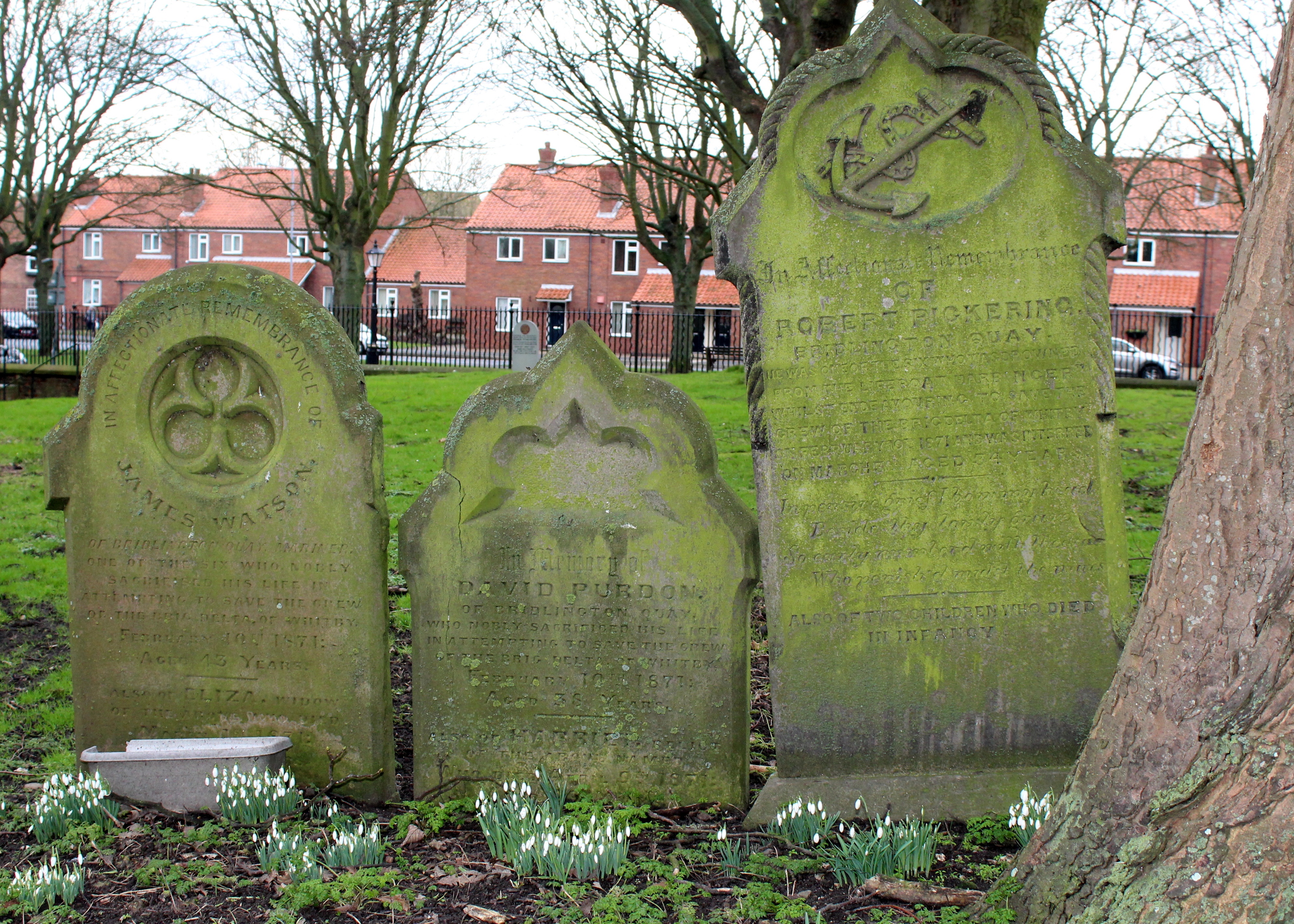 Three tombstones in a graveyard