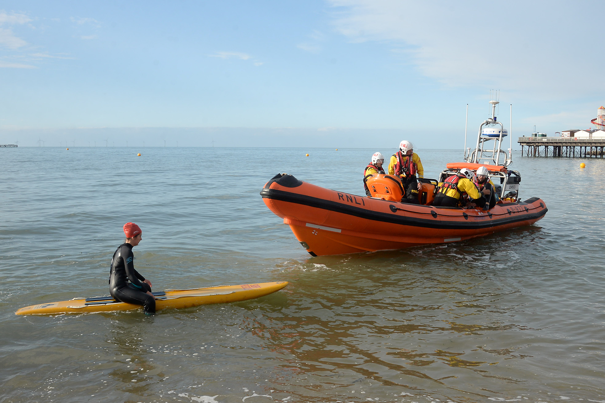 Lifeguard and rescue board wait whilst the casualty is bought onboard the lifeboat during the exercise held on Thursday evening.