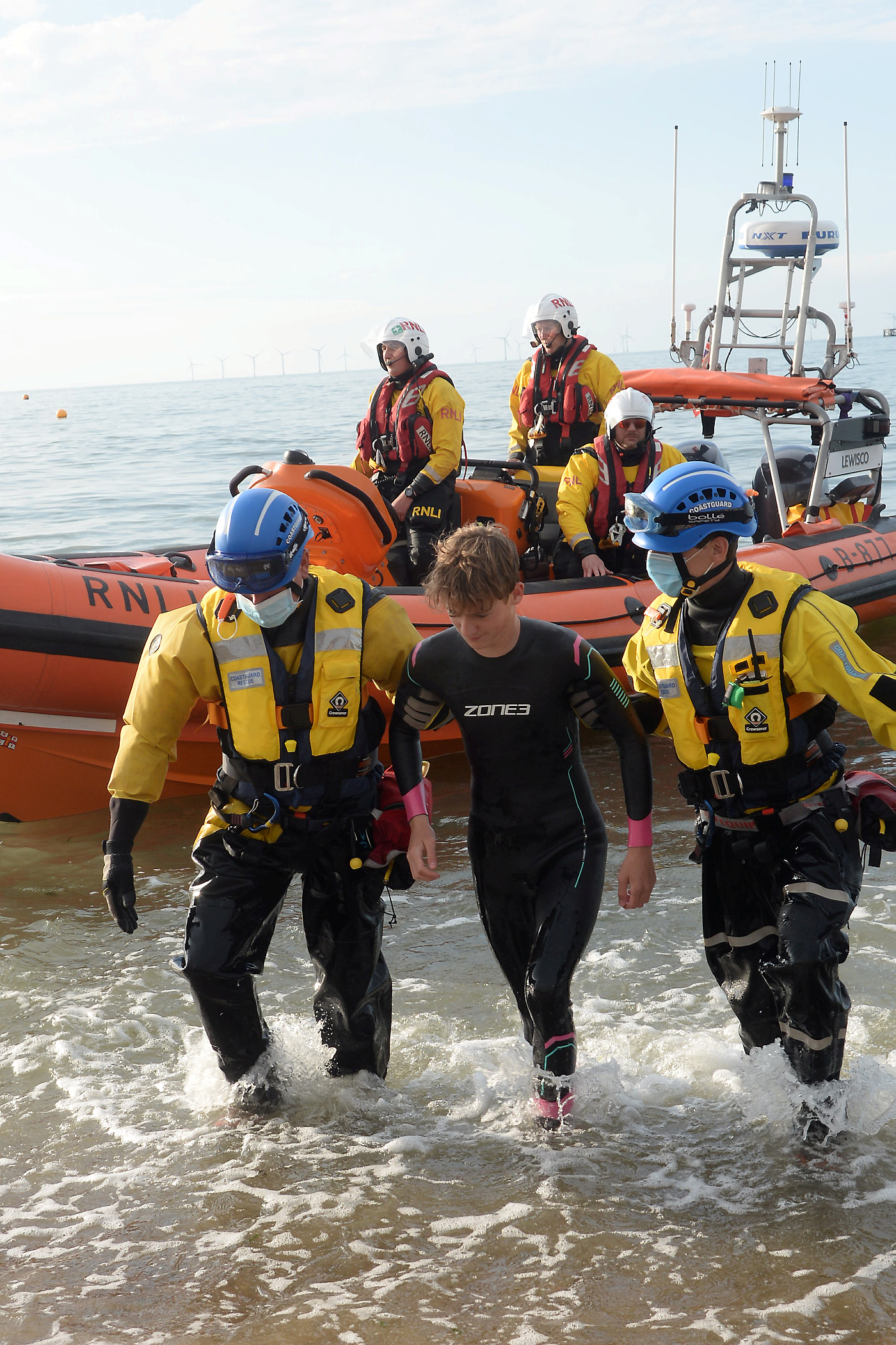 Members of the coastguard rescue team help the casualty (played by one oif the lifeguards) ashore during the exercise held on Thursday evening