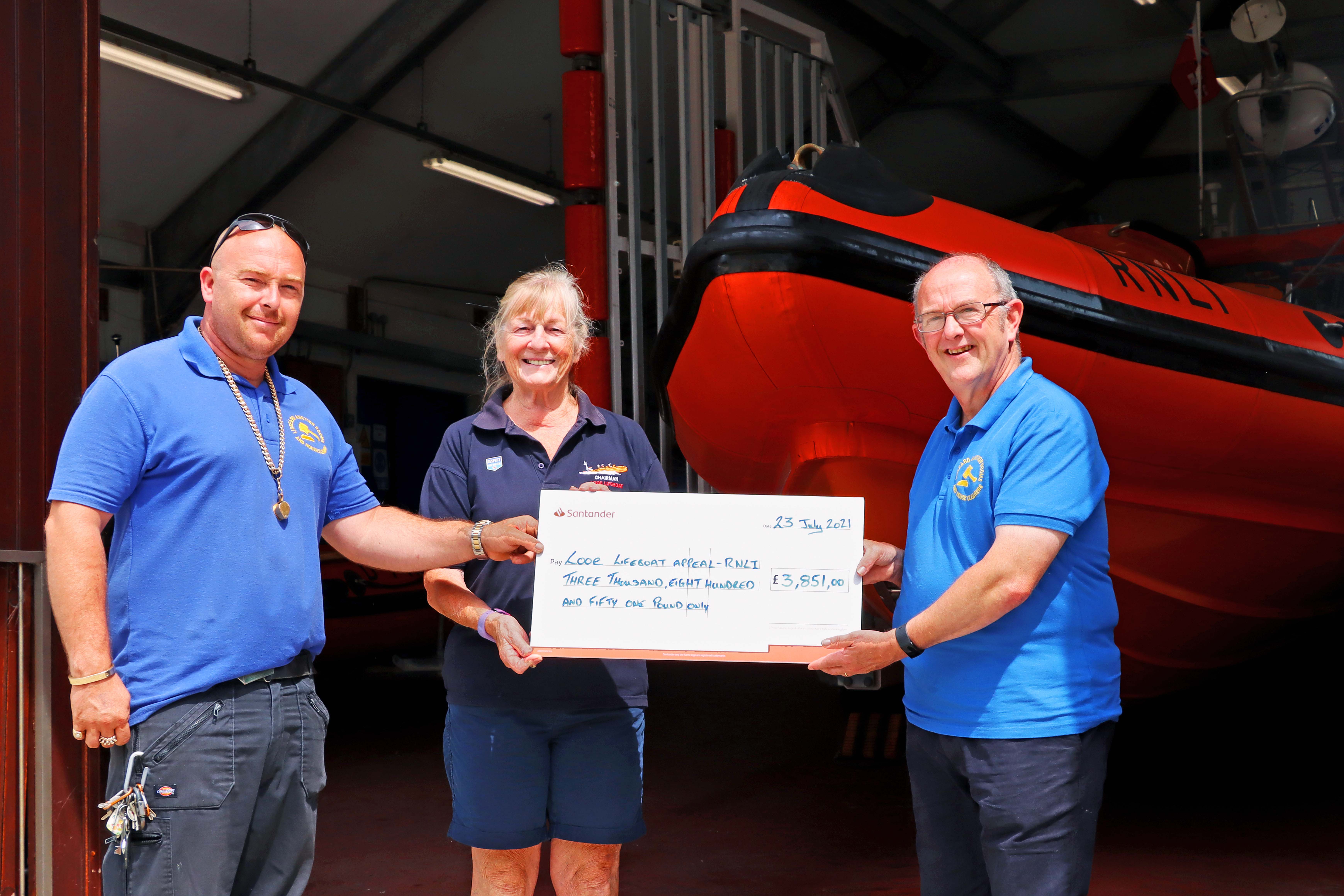 Ann Watson, Looe RNLI Management chair, receiving a cheque from Paul Pentland and Phil Harriman, Liskeard auction rooms Left to right Paul Pentland, Ann Watson and Phil Harriman