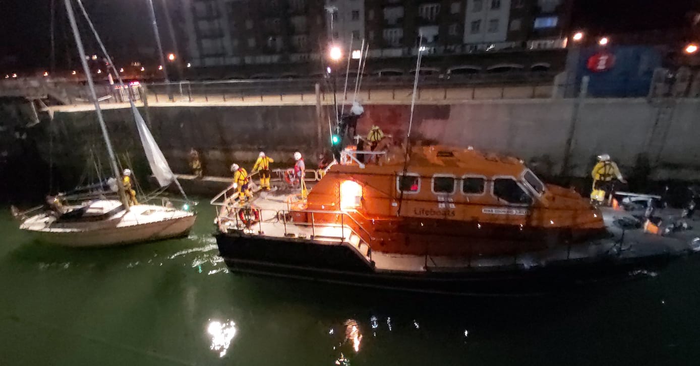 Eastbourne Lifeboat towing yacht into harbour