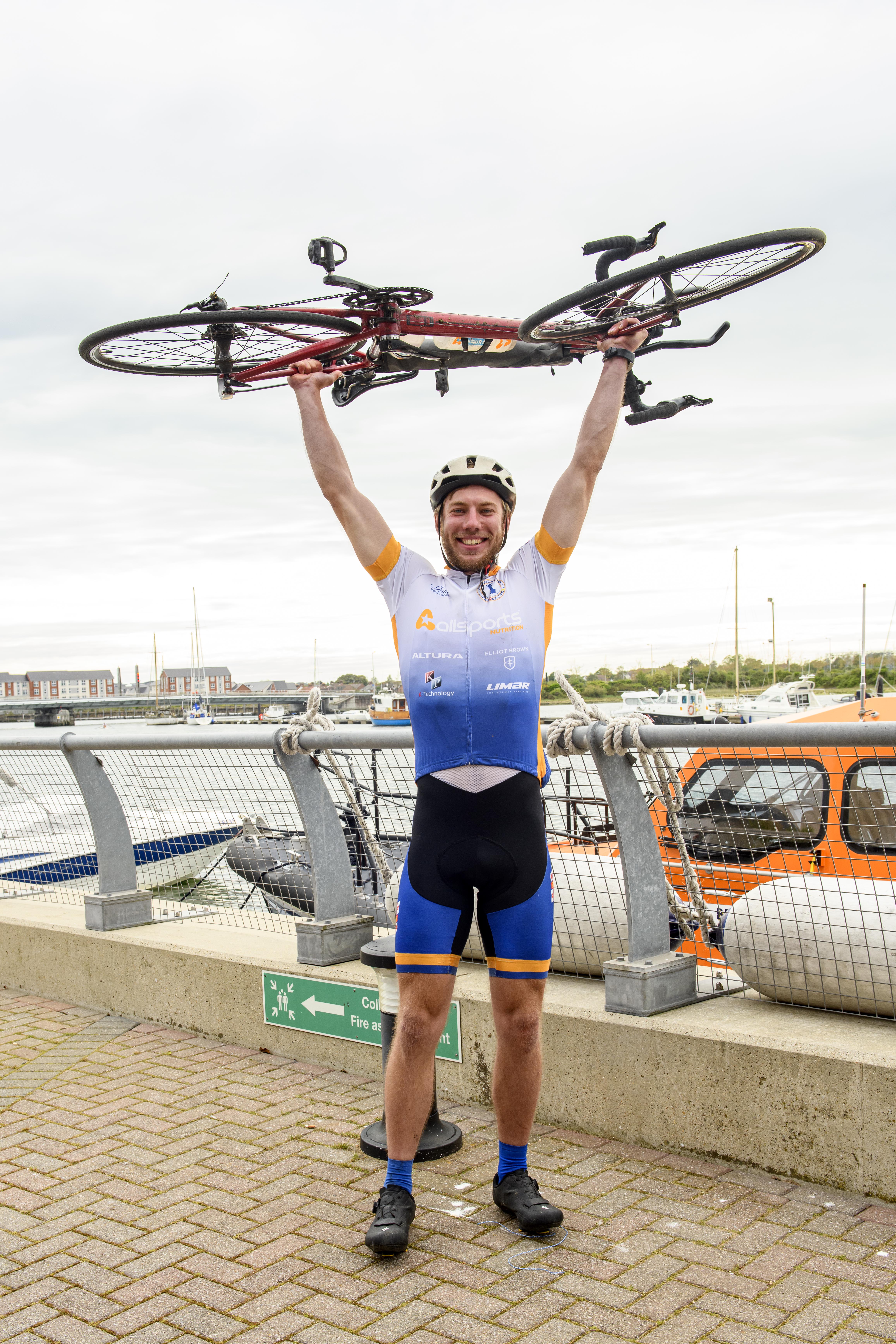 Elated Harry raises his cycle high at the RNLI College