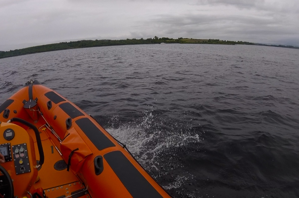 Over the bow of the lifeboat can be seen the casualty vessel aground close to shore