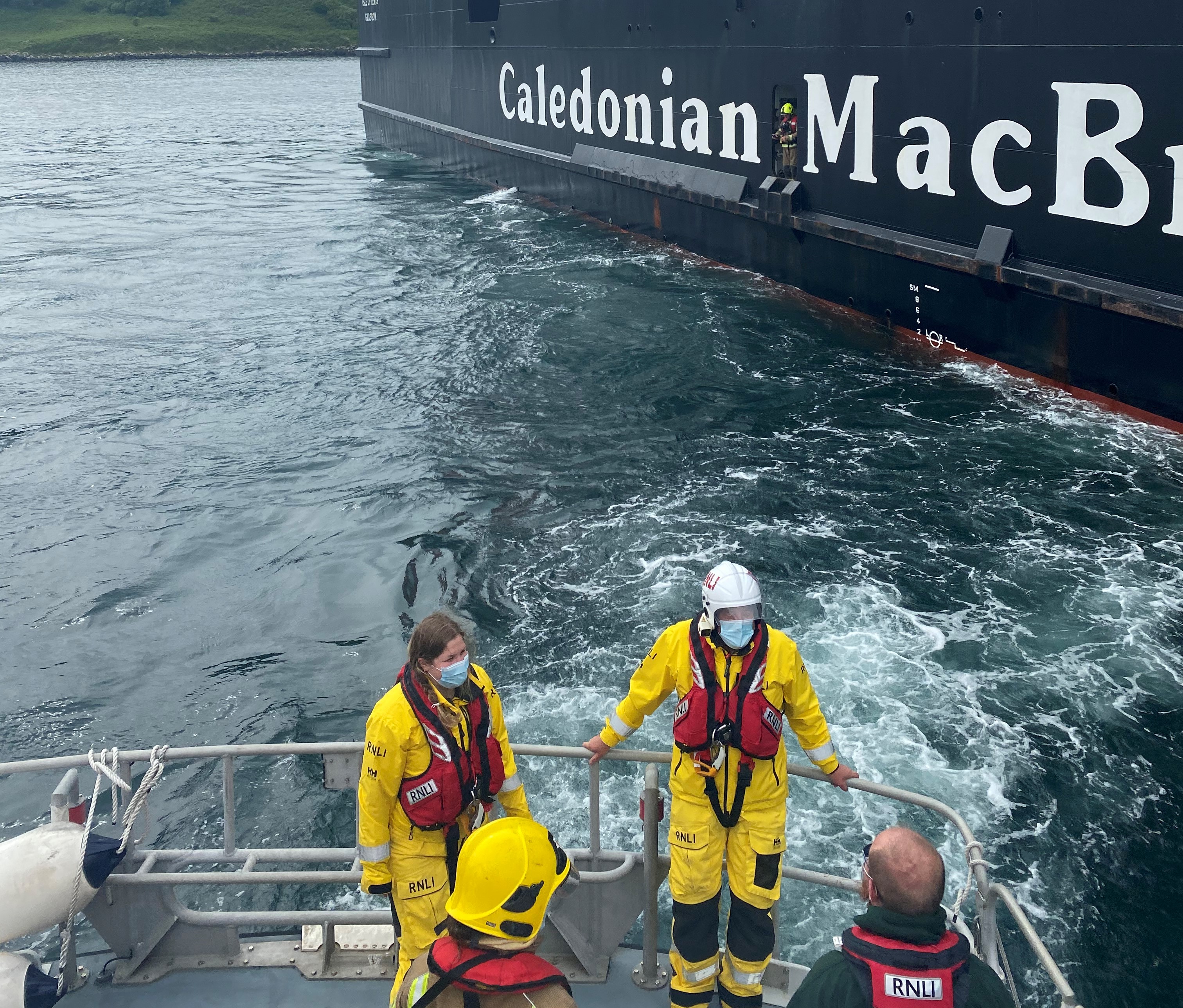 Lifeboat crew alongside ferry