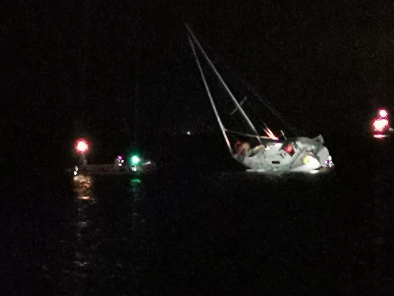 Troon inshore lifeboat alongside the casualty vessel aground outside Troon harbour
