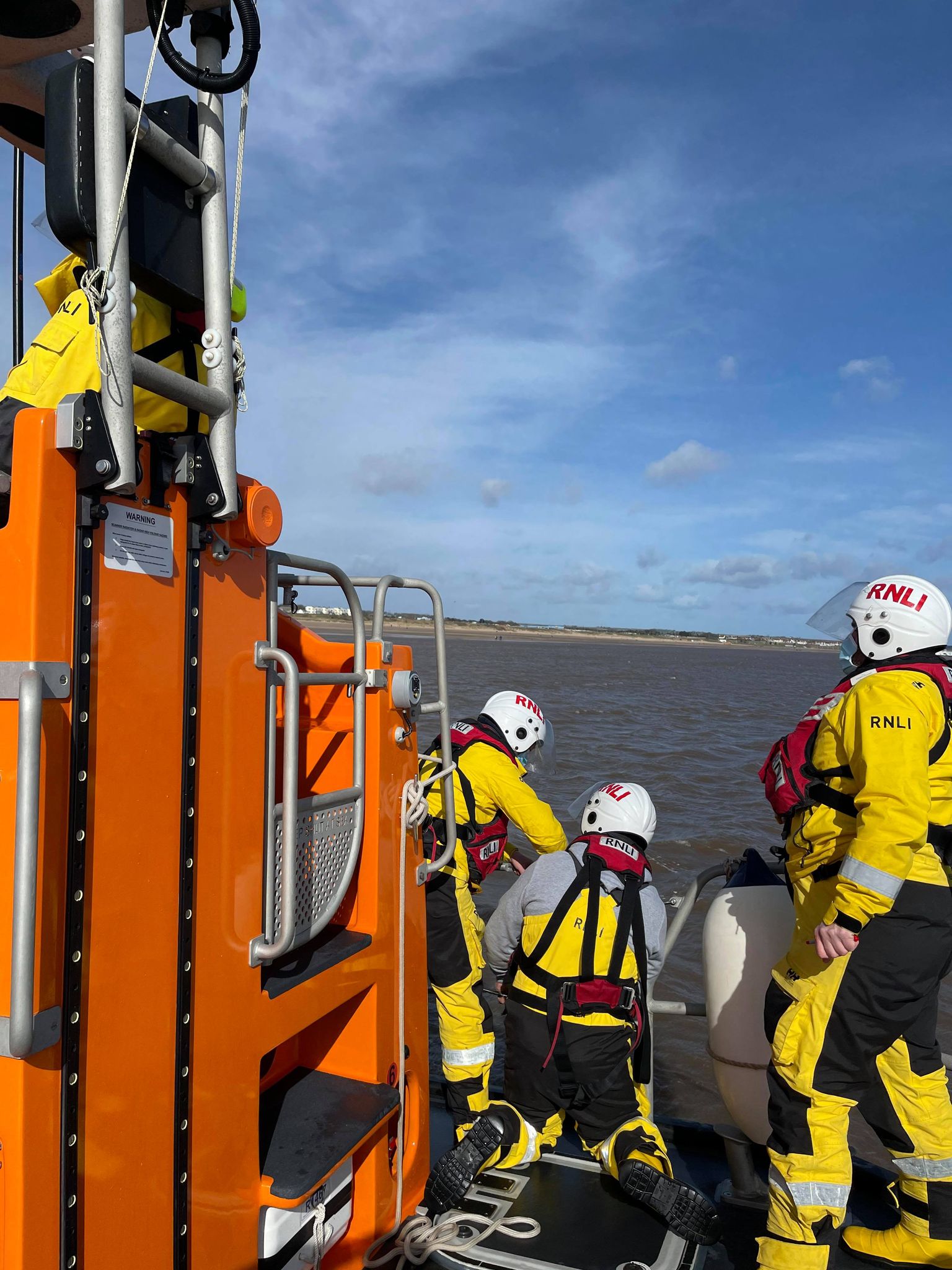 The all-weather lifeboat crew assisting the foil surfer.
