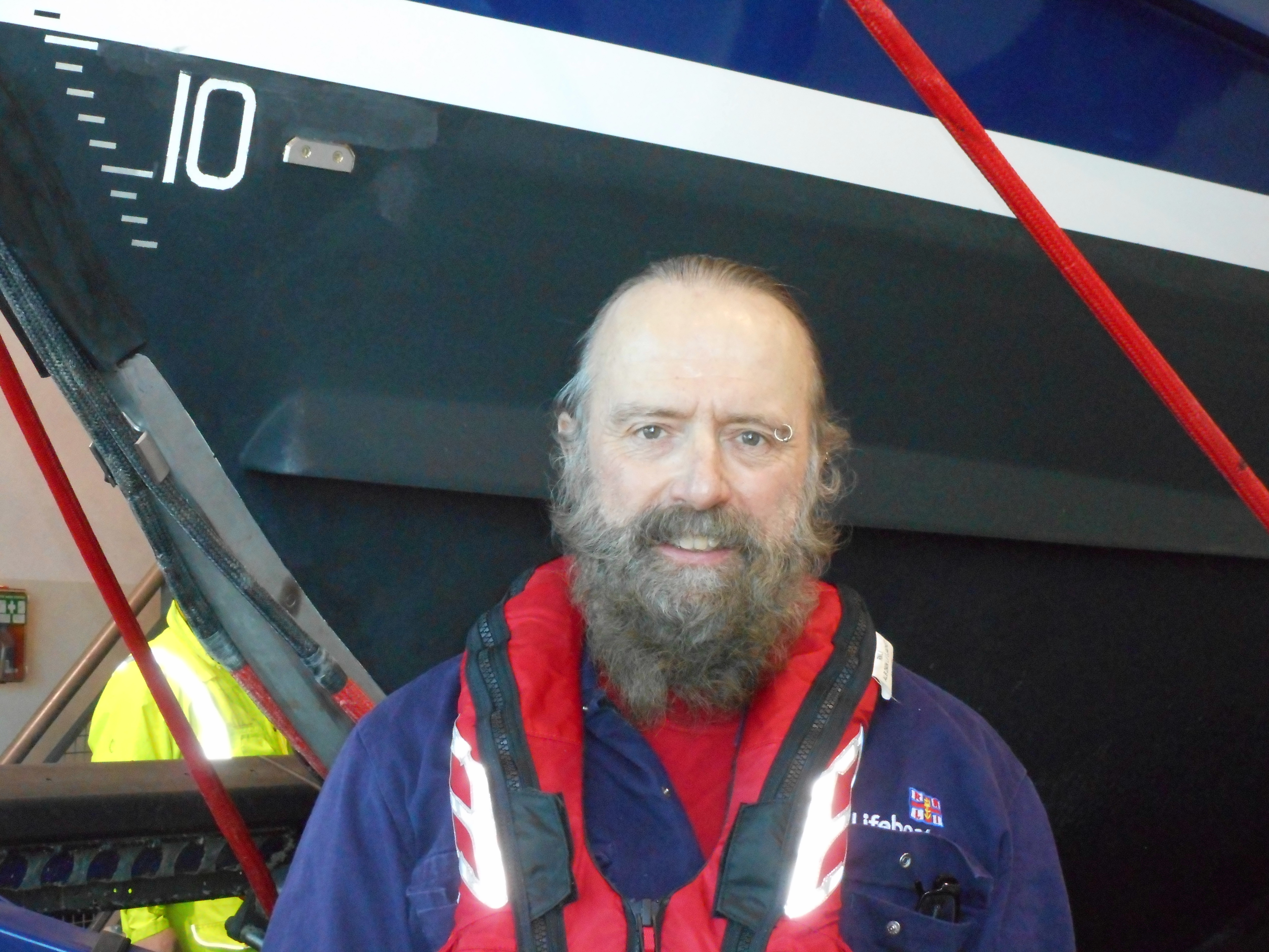 the head and shoulders of a man is shown in front of a lifeboat