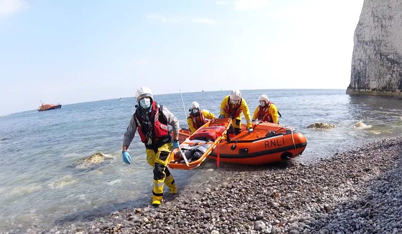 Stretcher being delivered to the cove to enable transfer of the casualty.