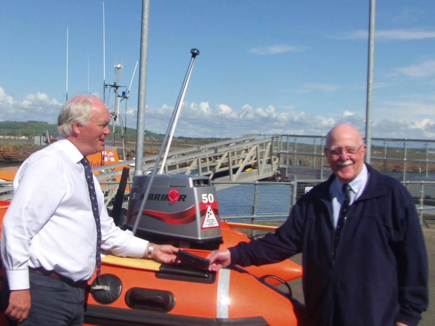 Retired Troon Coxswain, and current lifeboat station curator, Ian Johnson receiving his medal marking 50 years with the RNLI.