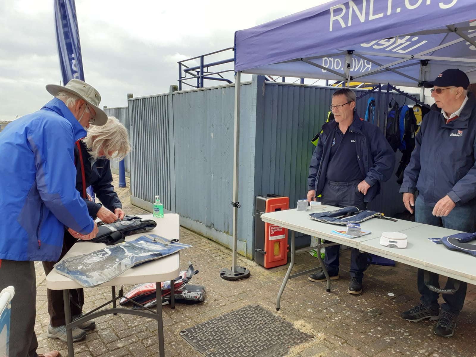 RNLI Volunteers giving instruction on checking lifejackets