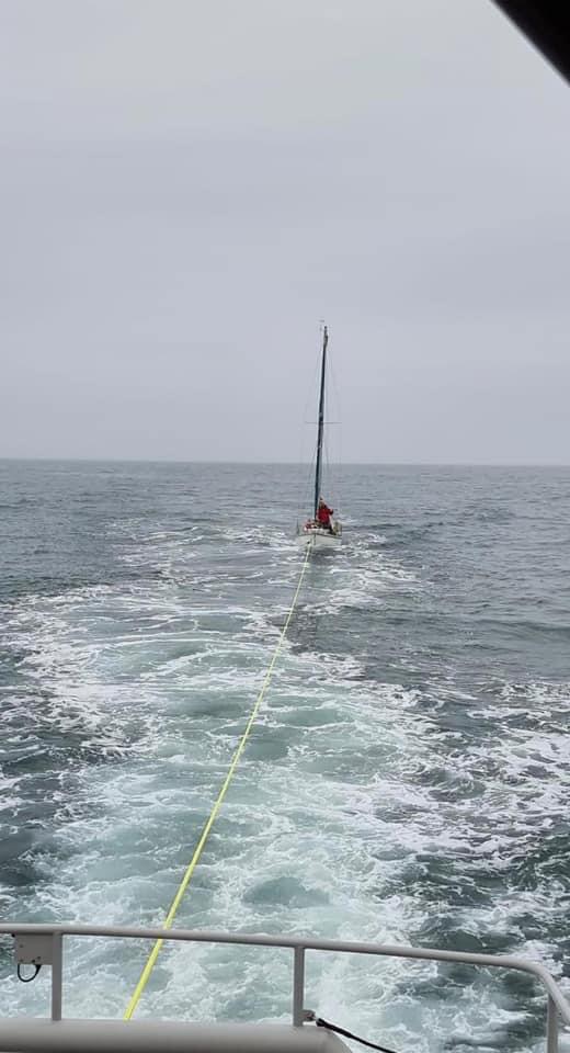 Yacht under tow heading for Milford Marina 