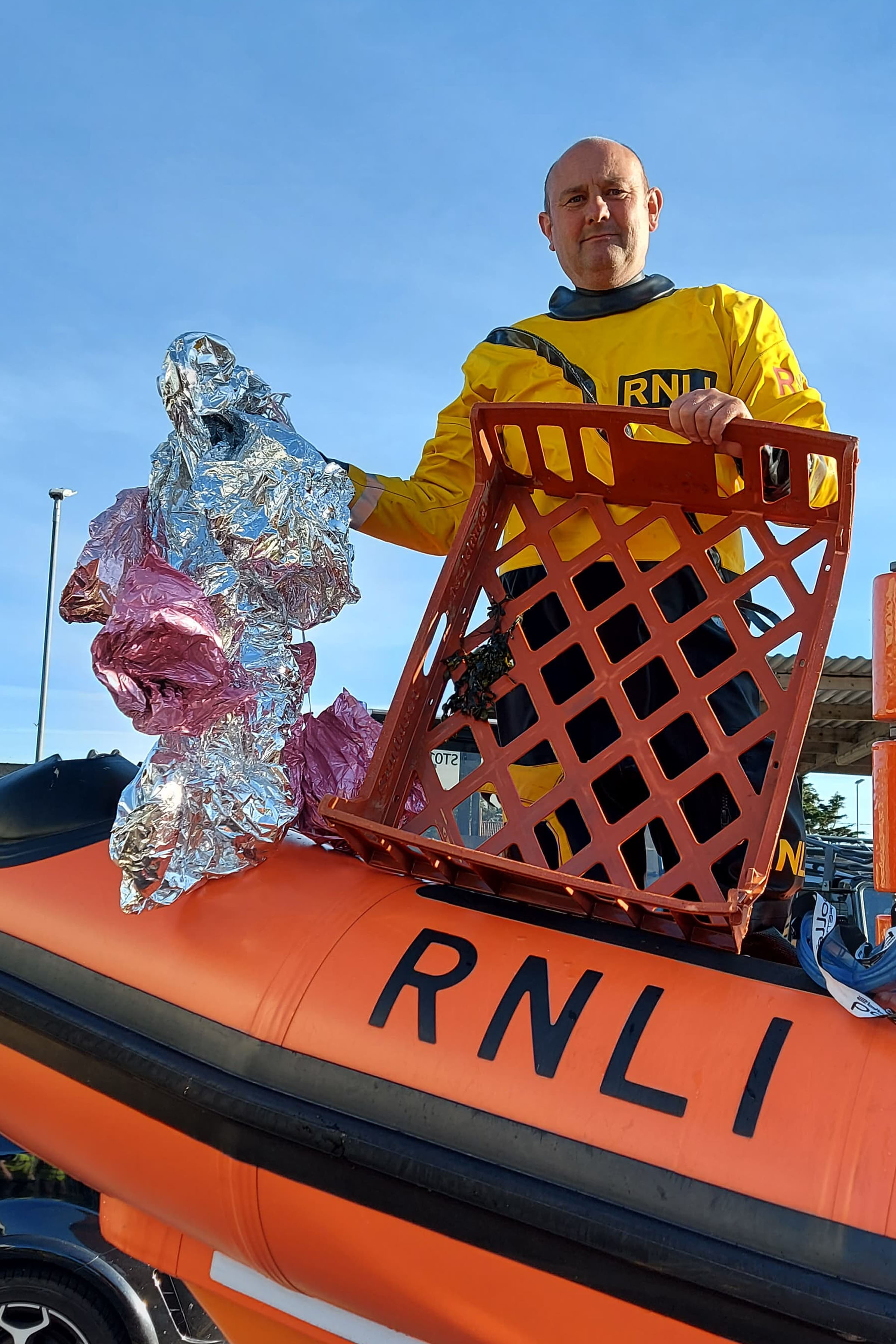 Burnham RNLI helmsman Stuart shows off the recovered balloons