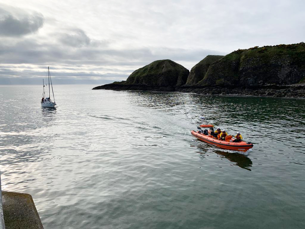 The crew of the Jamie Hunter lifeboat escort the sailing vessel into Stonehaven harbour