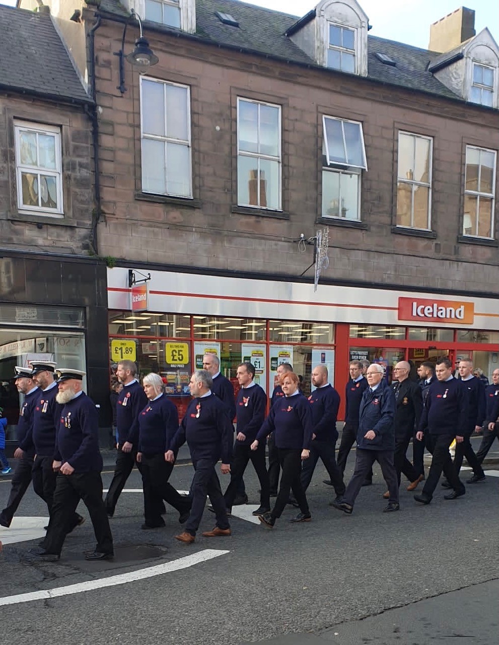 RNLI Crew marching through town where Town Mayor takes the salute