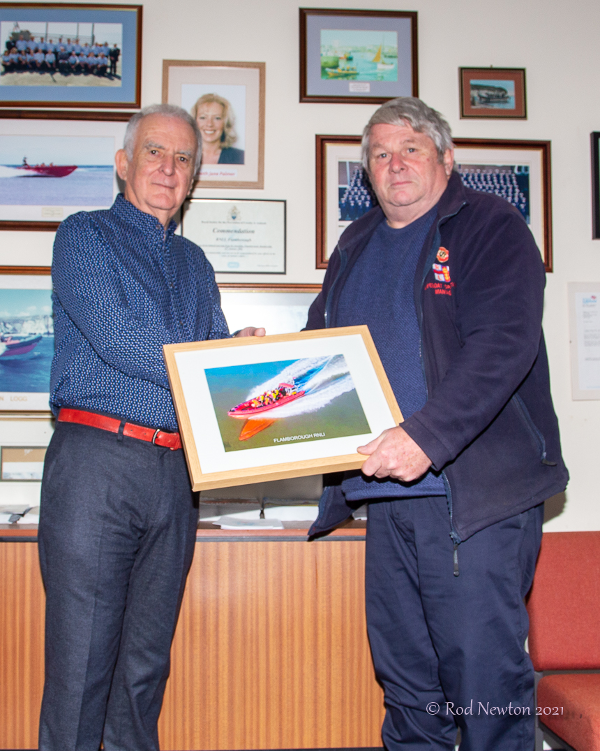 Lifeboats Operations Manager, David Freeman presenting a framed photograph to Bill Wraith
