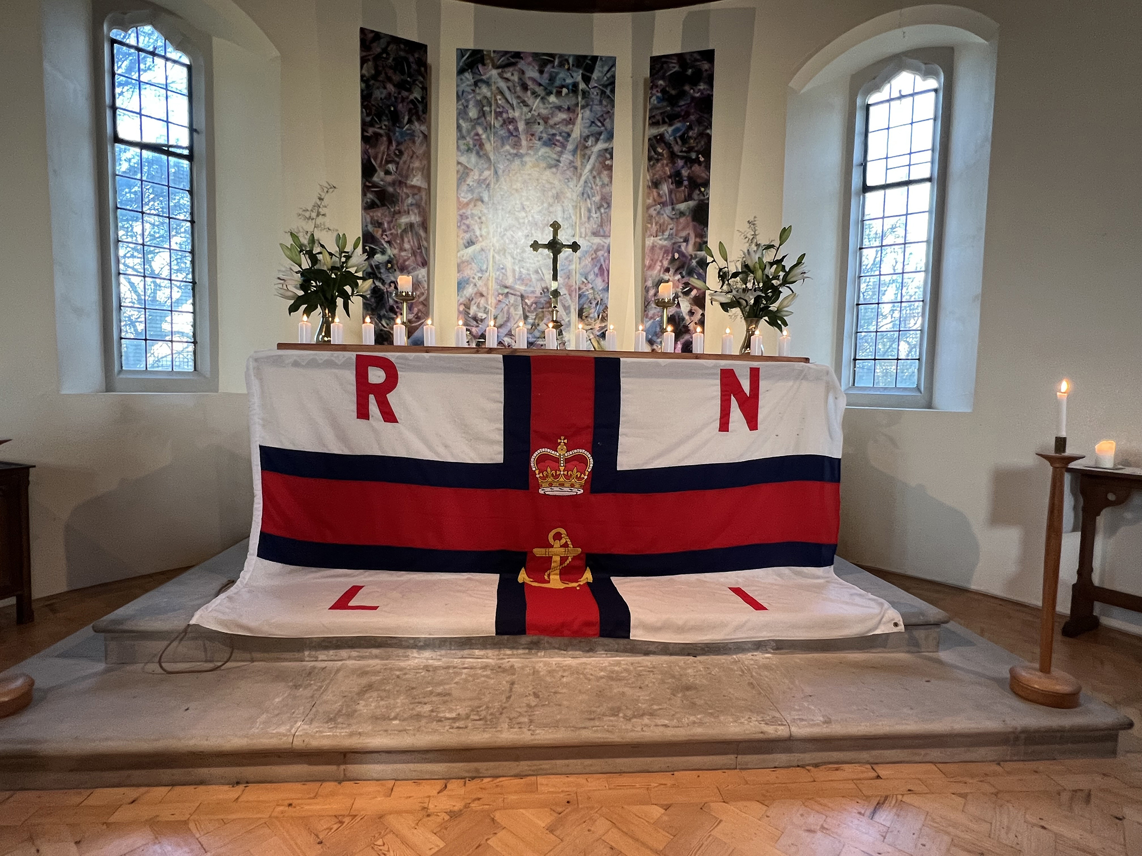 The church altar covered by the RNLI flag has seventeen candles on it in memory of the seventeen lost crewmen