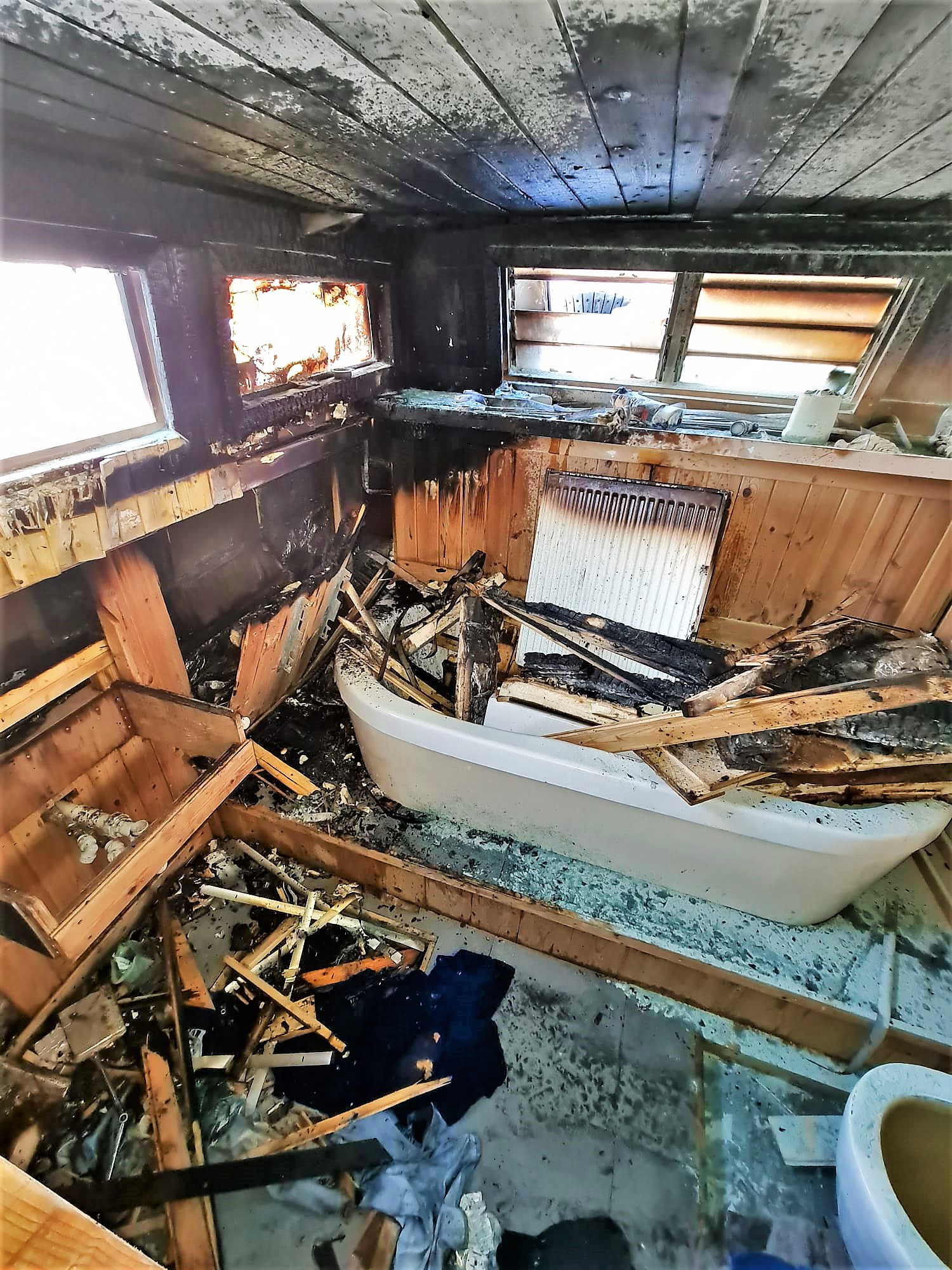 With the fire out the extent of the damage after an electrical fire can be seen below decks.