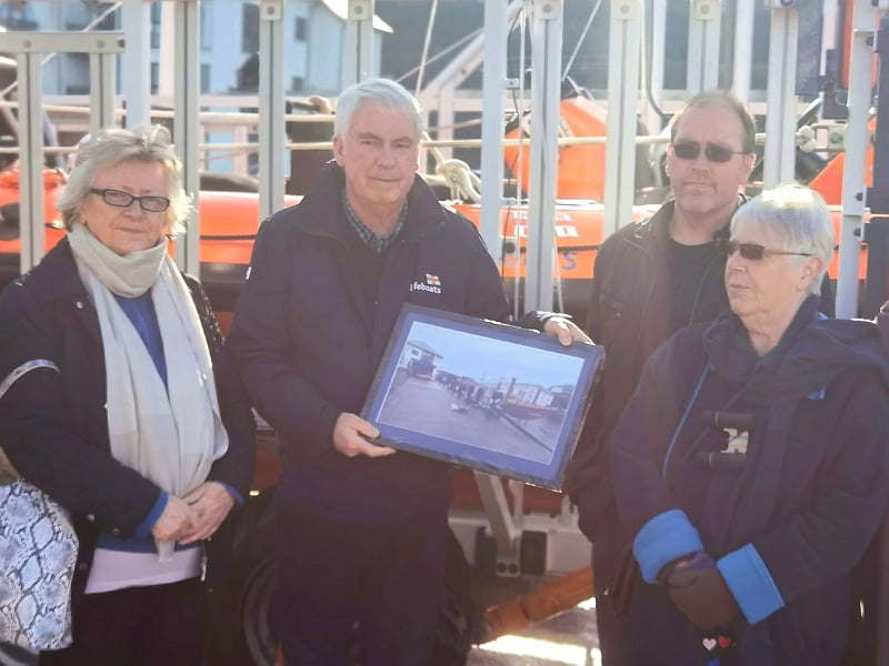 Presentation of photograph to family members