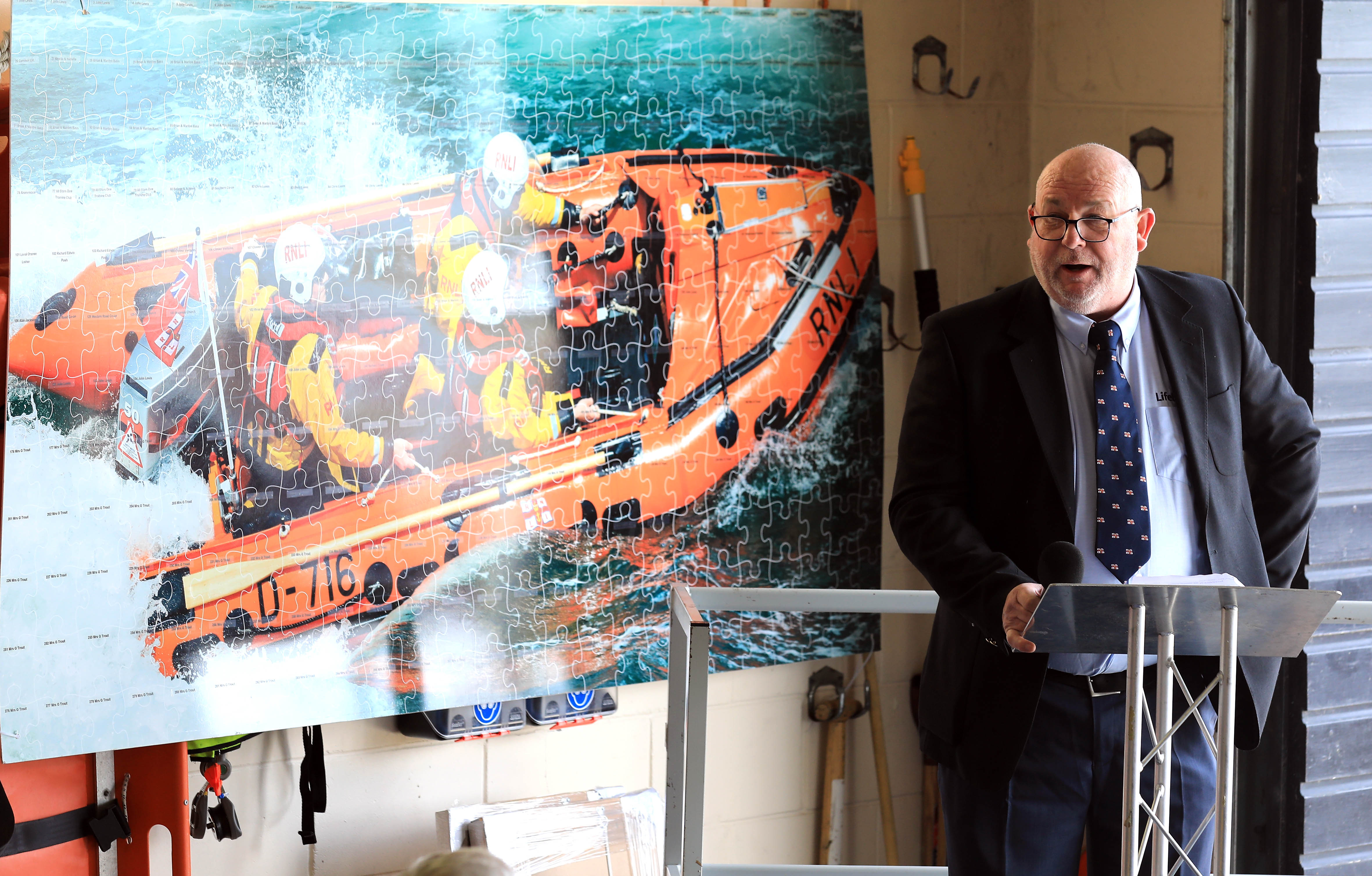 Portsmouth Lifeboat Operations Manager, Richard Butler, standing by the fundraising jigsaw.