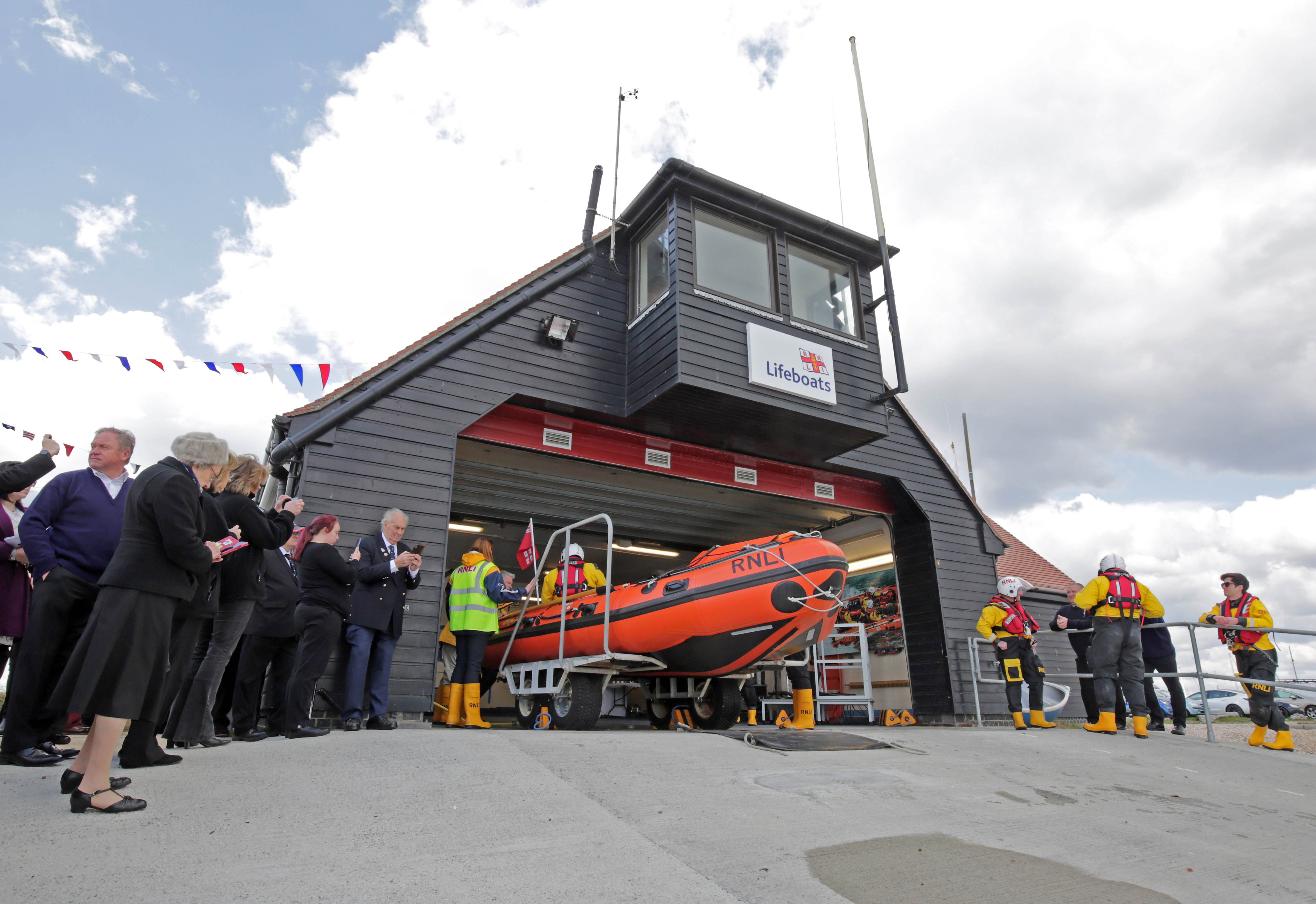 Photo of the lifeboat station with the new lifeboat about to launch down the slipway.