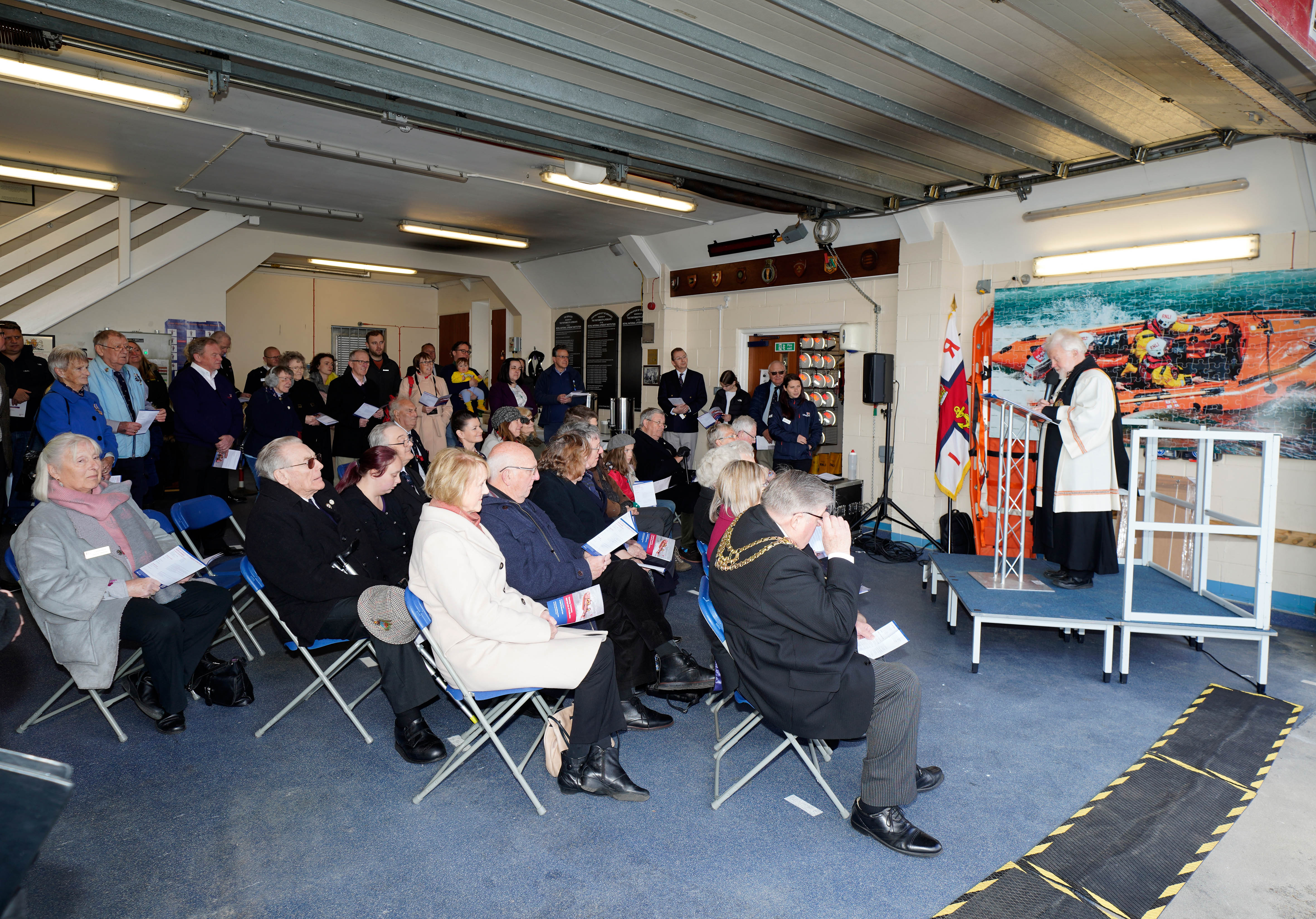The Revd Dr John Strain leads the Service of Dedication in front of attendees at the station.
