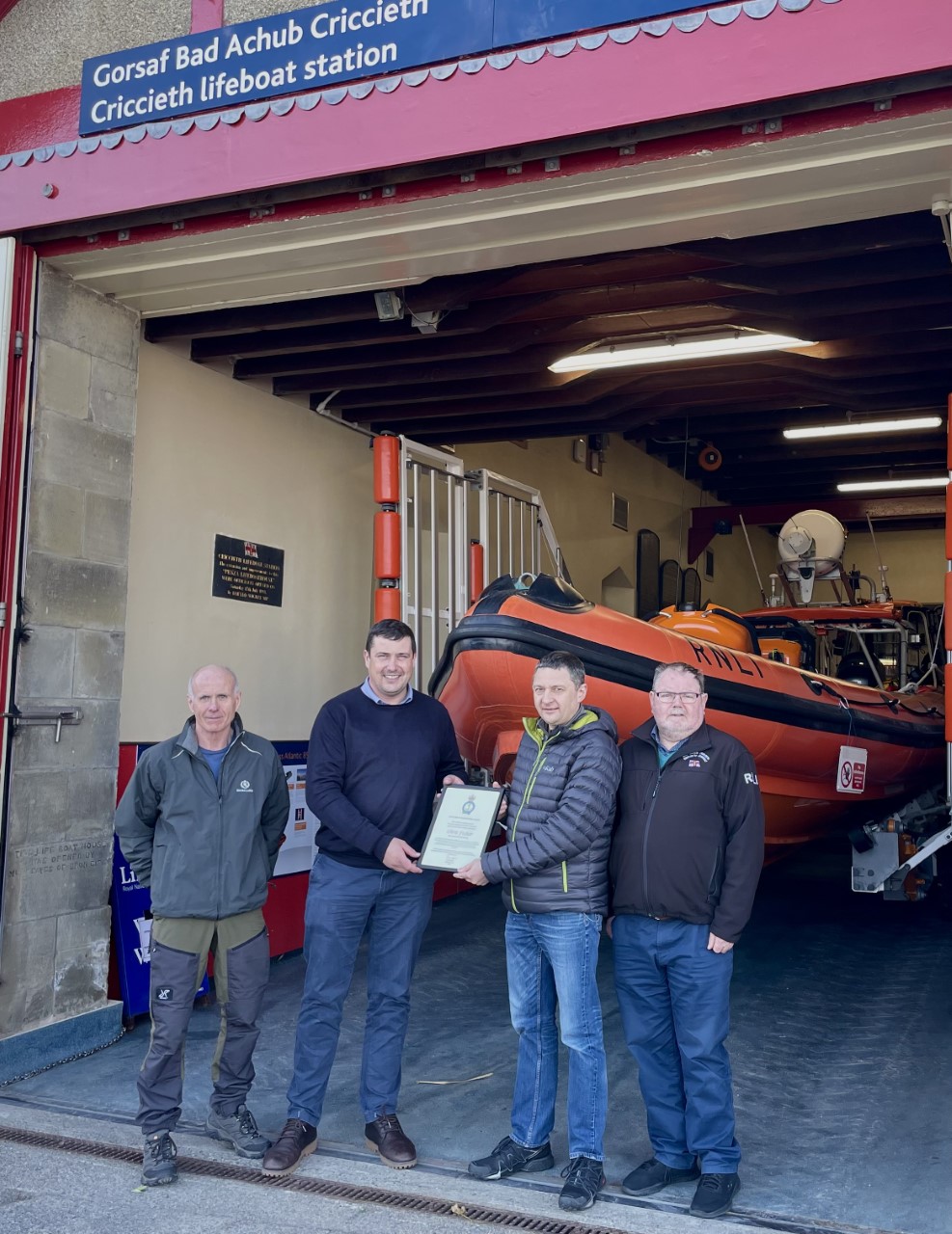 Chris Fisher presented with an RNLI Excellence in Volunteering Award by Andy Dodd, Area Lifesaving Manager. Pictured L-R Clive Moore (LOM), Andy Dodd (ALM), Chris Fisher, Peter Williams (Chairman)
