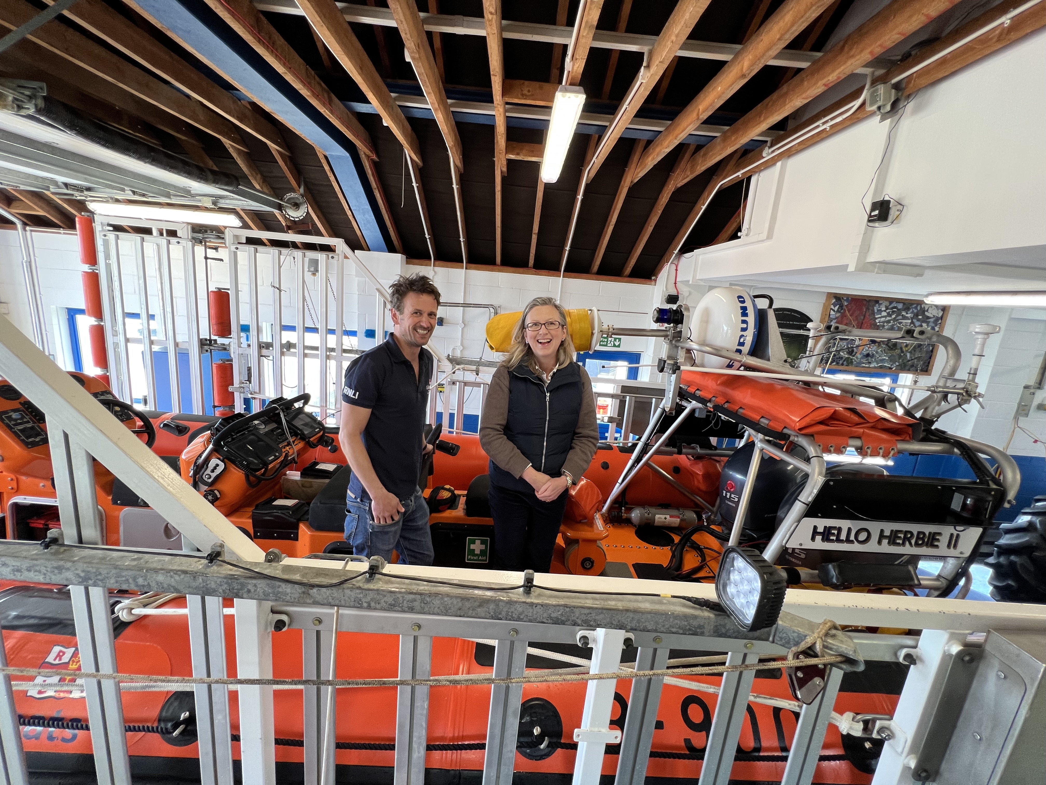Sally-Ann Hart and a boat crew volunteer stand together in the Atlantic 85 lifeboat