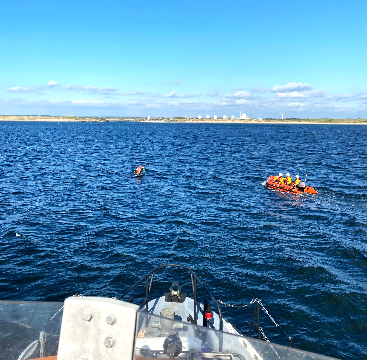 Troon RNLI inshore lifeboat approaching the kayakers off the coast at Irvine