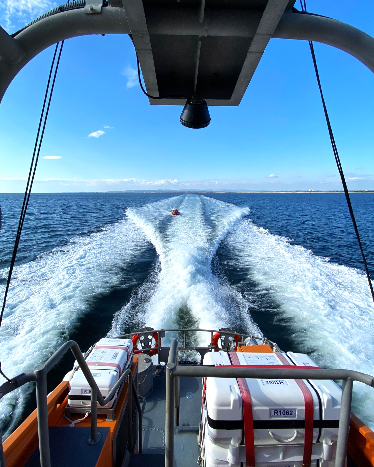 Troon RNLI inshore lifeboat in the wake of the all-weather lifeboat