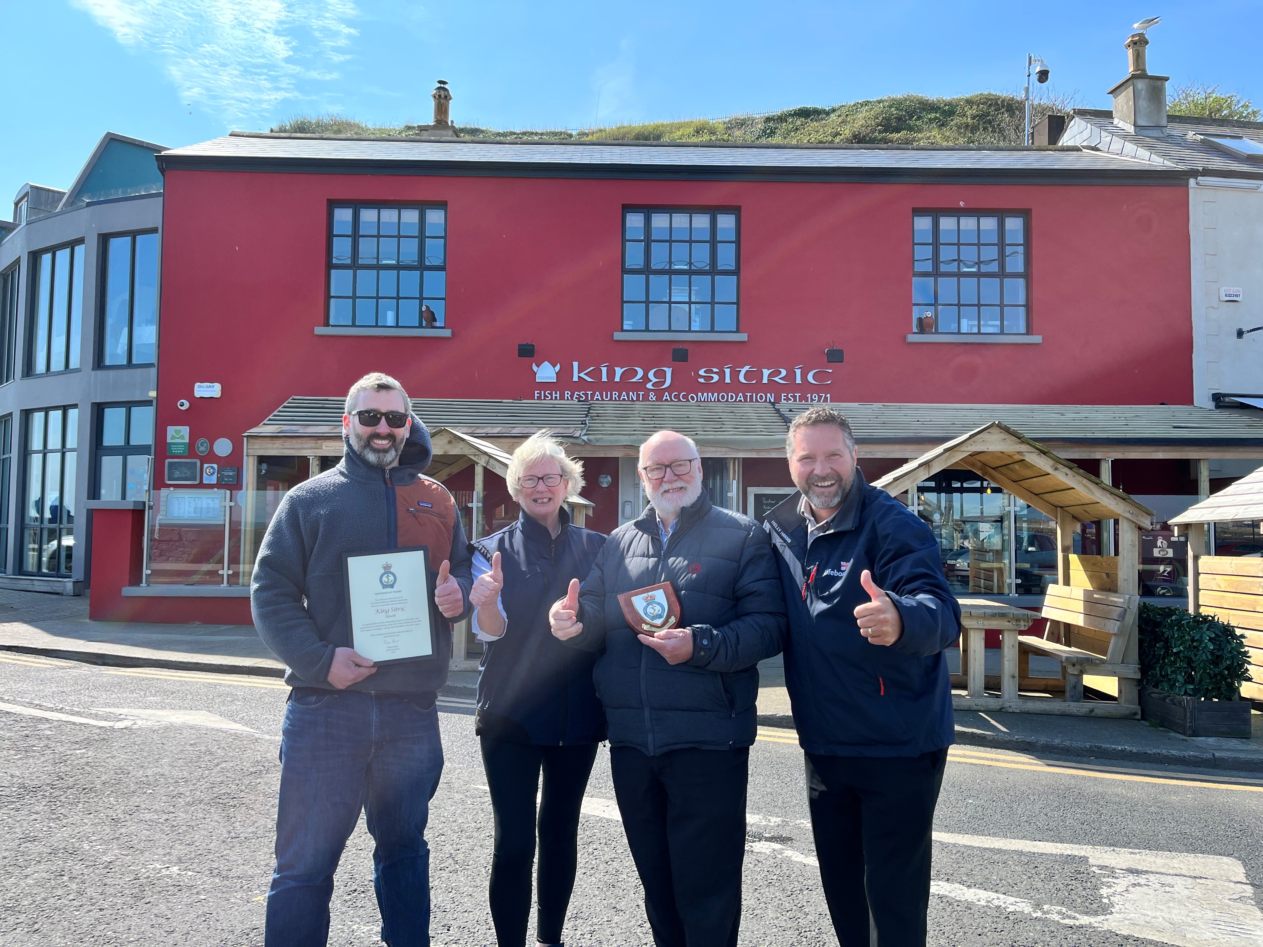 Head of Engagement of the RNLI Pete Emmett presents letter of thanks to Joan, Aidan &amp; Dec Mac Manus from The King Sitric Seafood Bar who raised over €35,000 for the RNLI